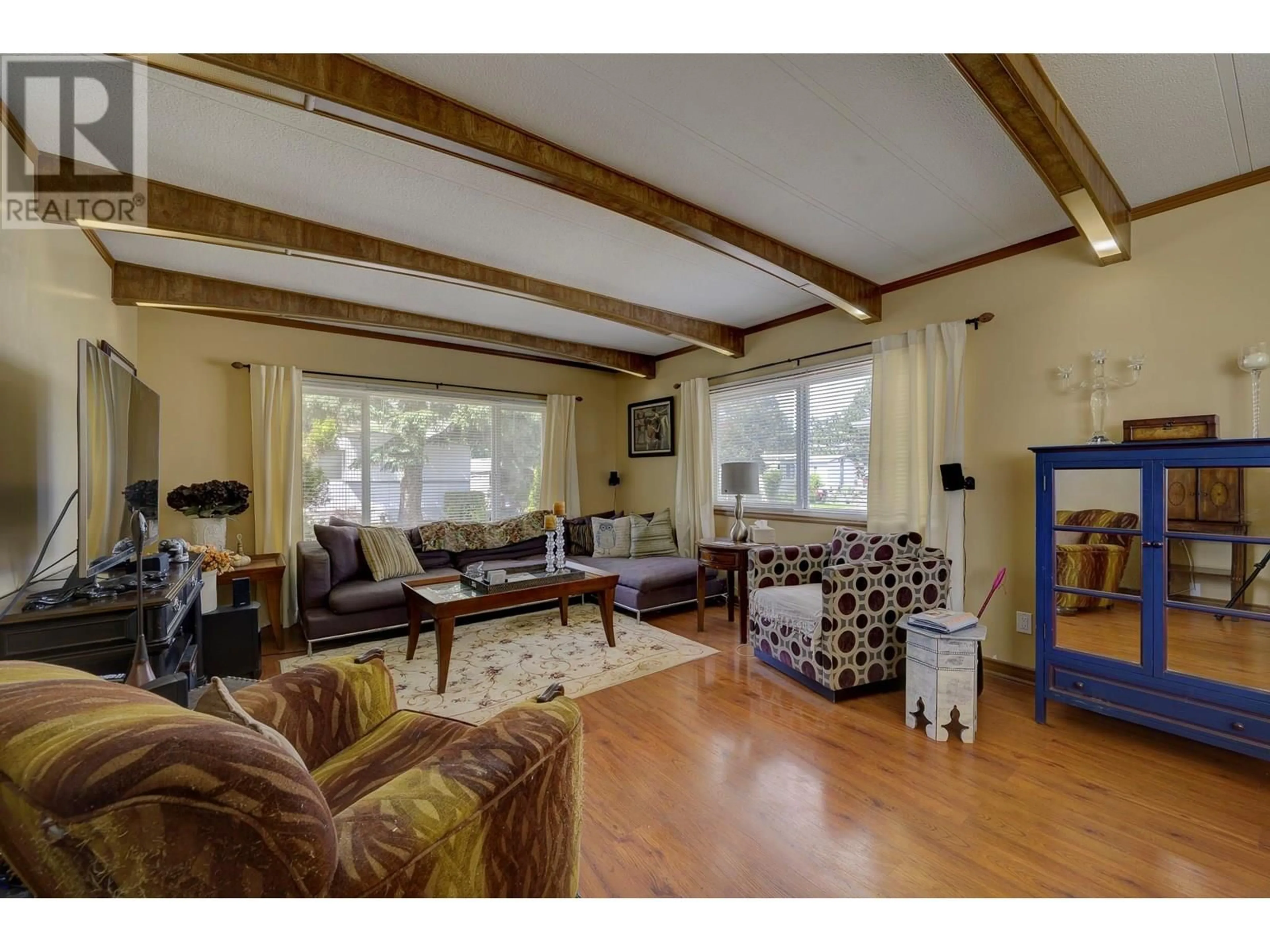 Living room with furniture, wood/laminate floor for 216 - 2400 OAKDALE WAY, Kamloops British Columbia V2B6W7