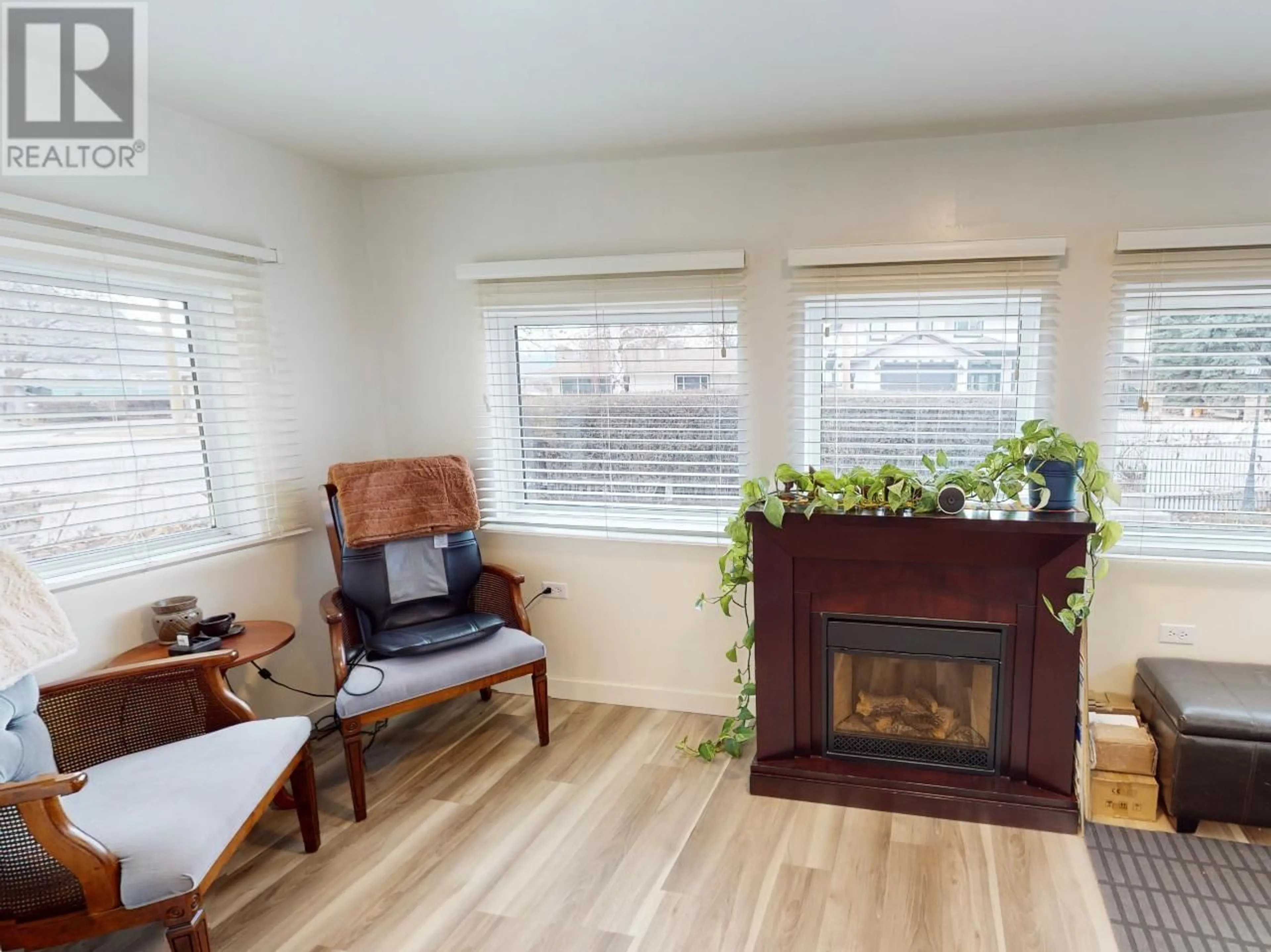 Living room with furniture, wood/laminate floor for 8310 KINGFISHER DRIVE, Osoyoos British Columbia V0H1V1