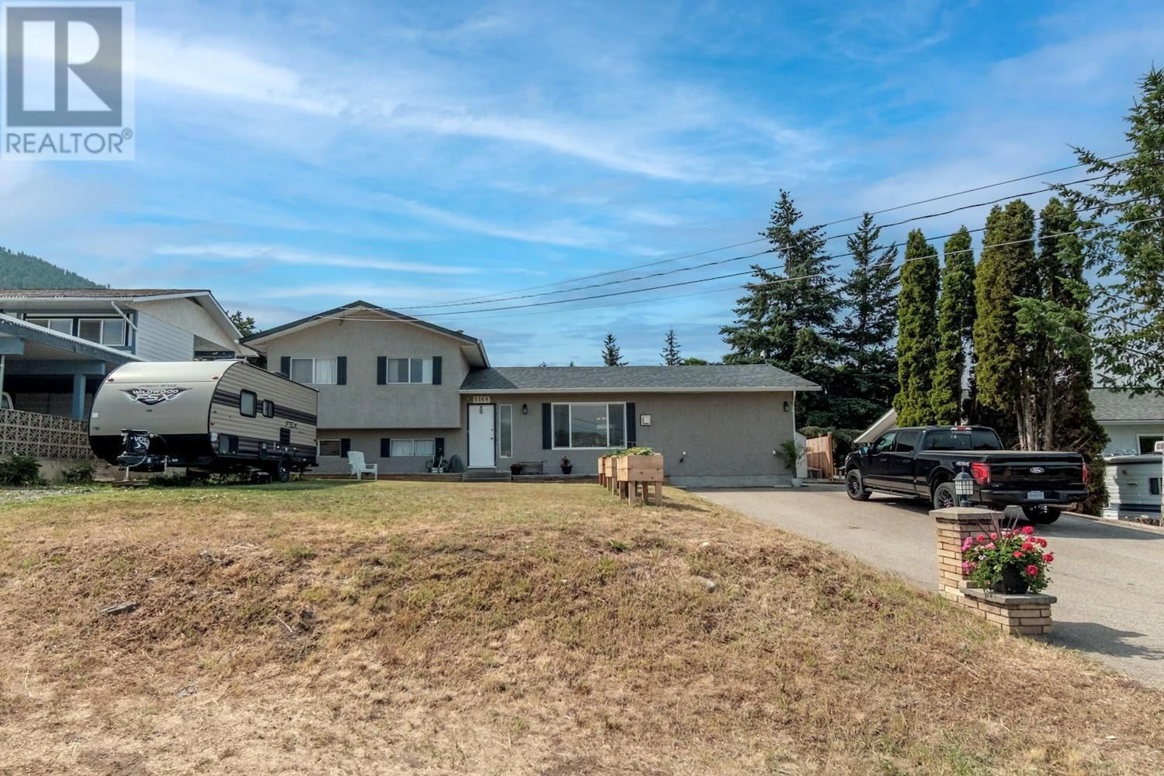 A pic from outside/outdoor area/front of a property/back of a property/a pic from drone, street for 5168 HAYNES ROAD, Vernon British Columbia V1B3J6