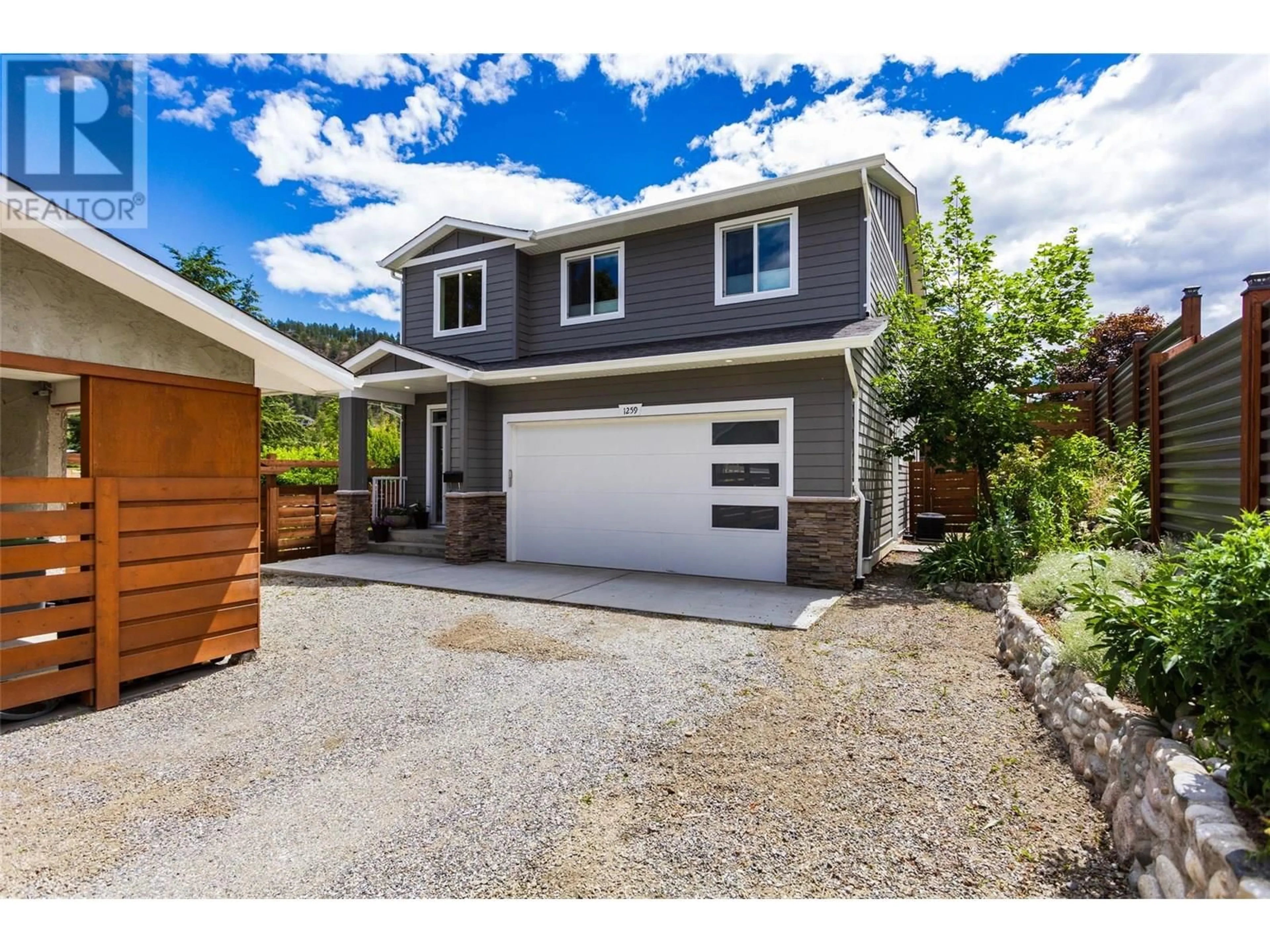 Home with vinyl exterior material, street for 1259 RIO DRIVE, Kelowna British Columbia V1V1E2