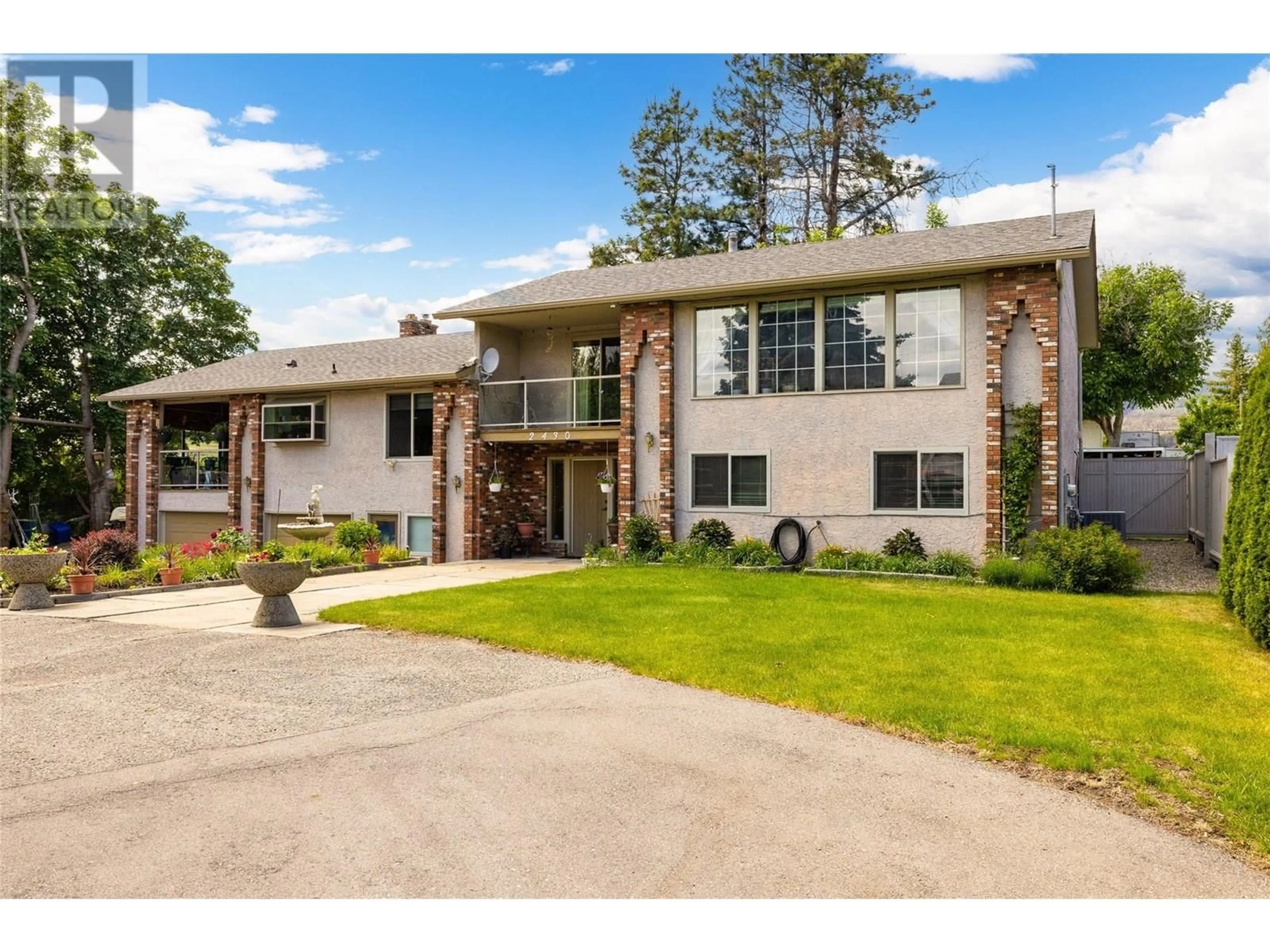 Home with brick exterior material, street for 2430 CRESTVIEW ROAD, West Kelowna British Columbia V1Z1Z1