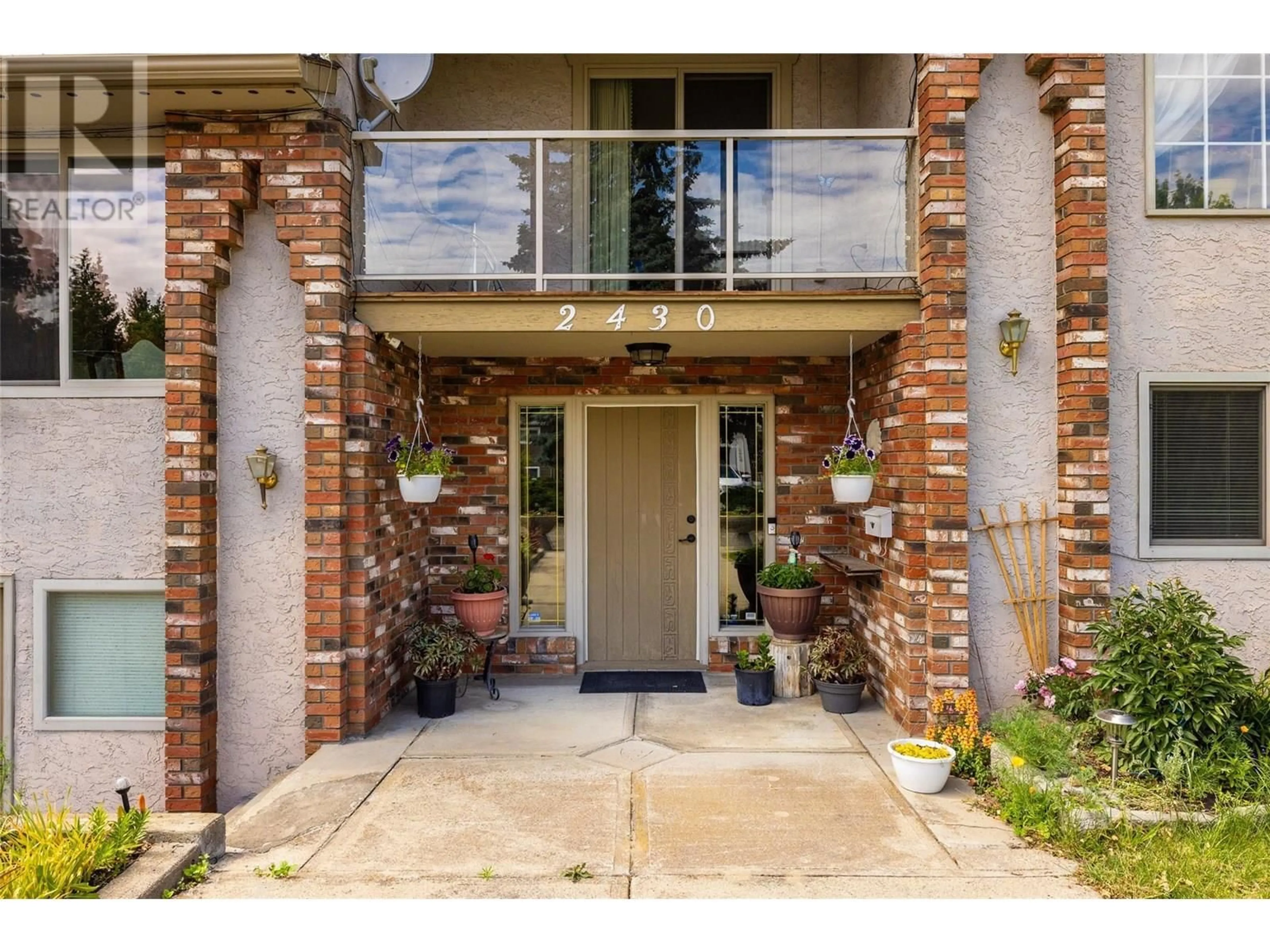 Home with brick exterior material, street for 2430 CRESTVIEW ROAD, West Kelowna British Columbia V1Z1Z1