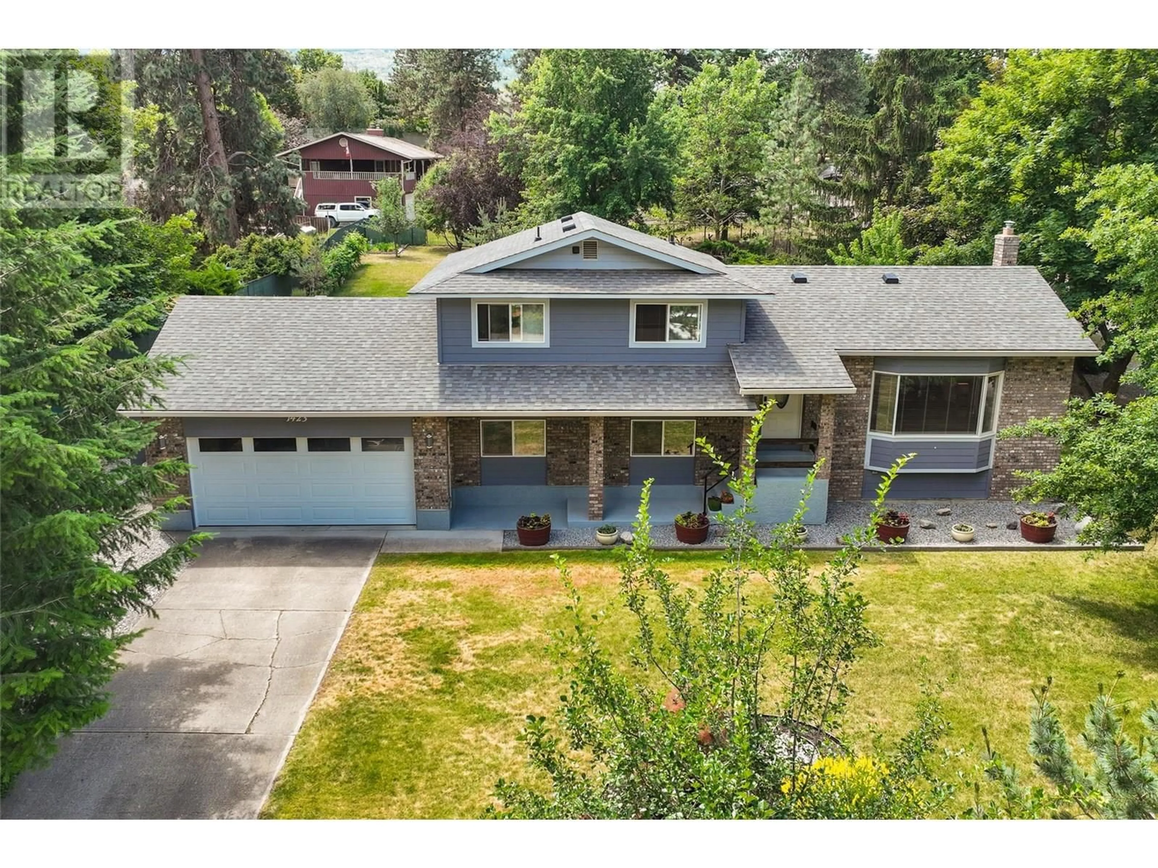 A pic from outside/outdoor area/front of a property/back of a property/a pic from drone, street for 1423 MISSION RIDGE DRIVE, Kelowna British Columbia V1W3B1