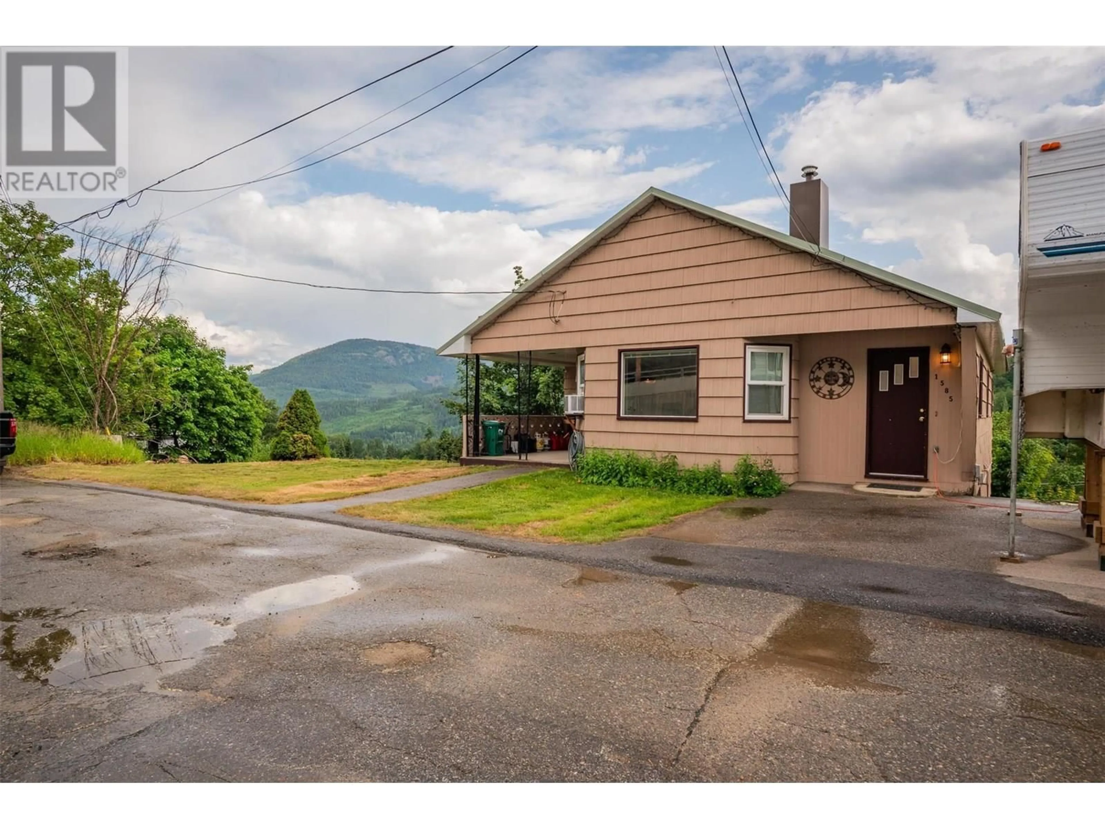 A pic from outside/outdoor area/front of a property/back of a property/a pic from drone, mountain view for 1585 DUNN CRESCENT, Rossland British Columbia V0G1Y0