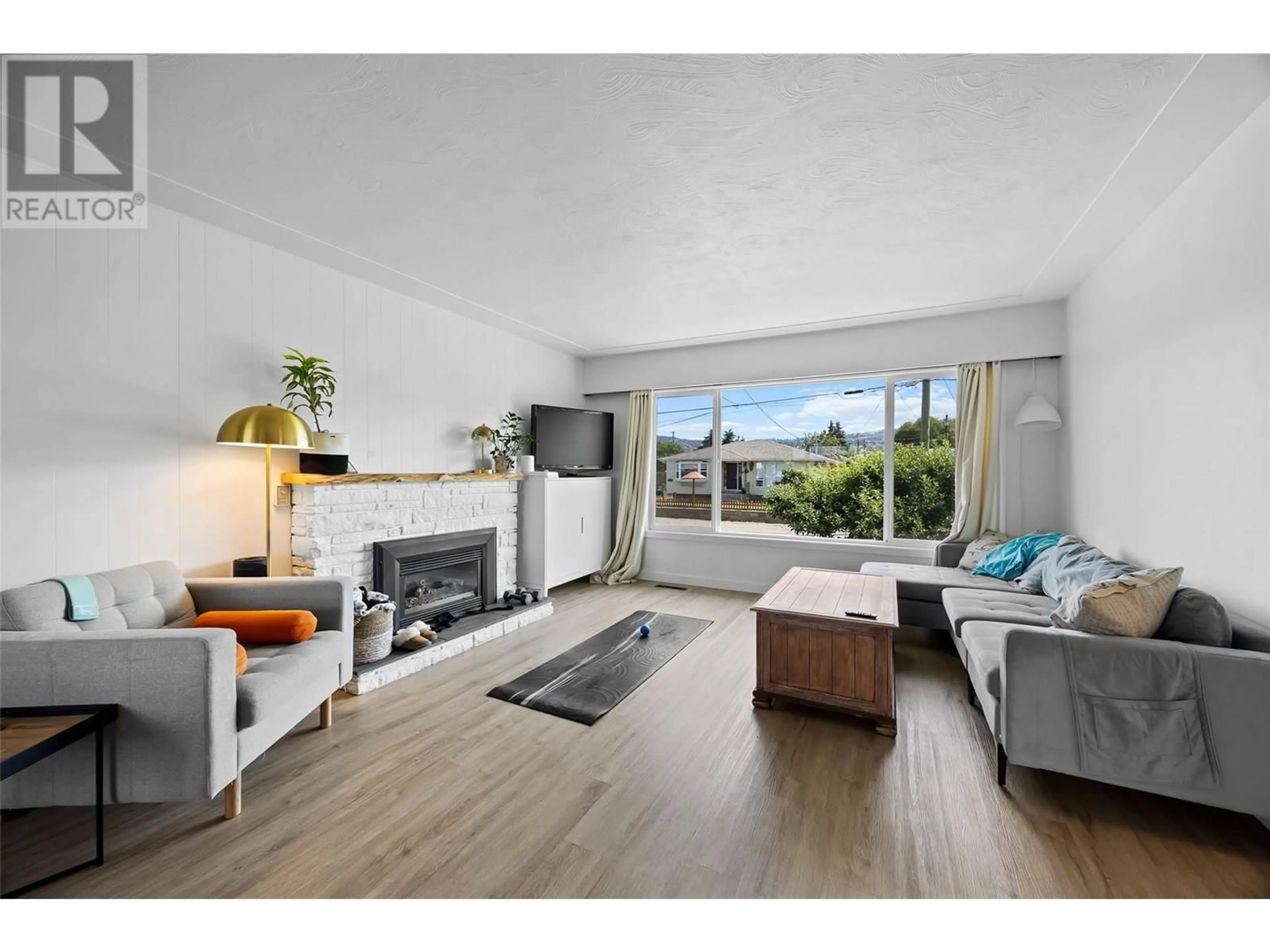 Living room with furniture, wood/laminate floor for 239 CHESTNUT AVENUE, Kamloops British Columbia V2B1L4