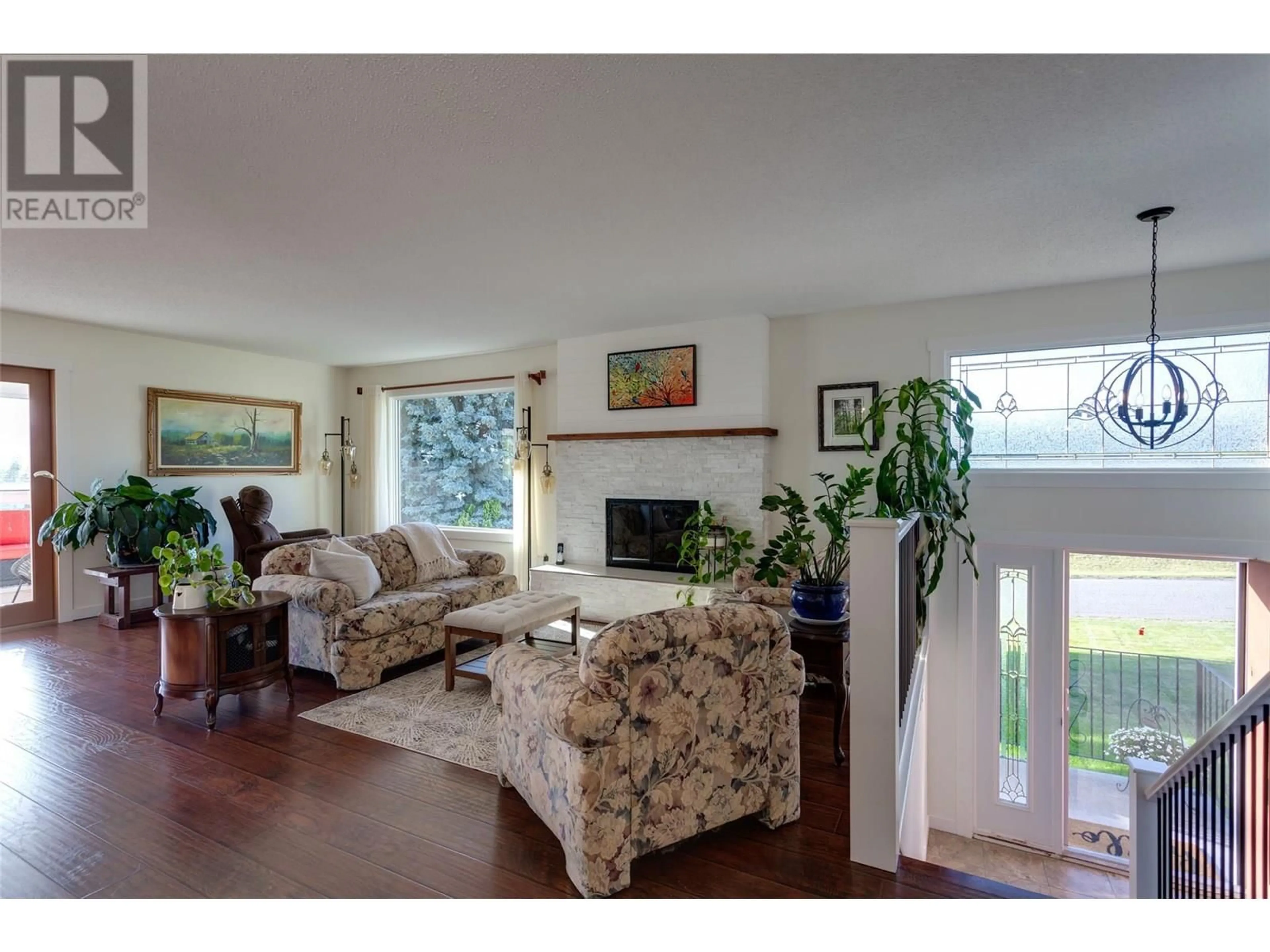 Living room with furniture, wood/laminate floor for 1675 STAYMAN ROAD, Kelowna British Columbia V1P1B2