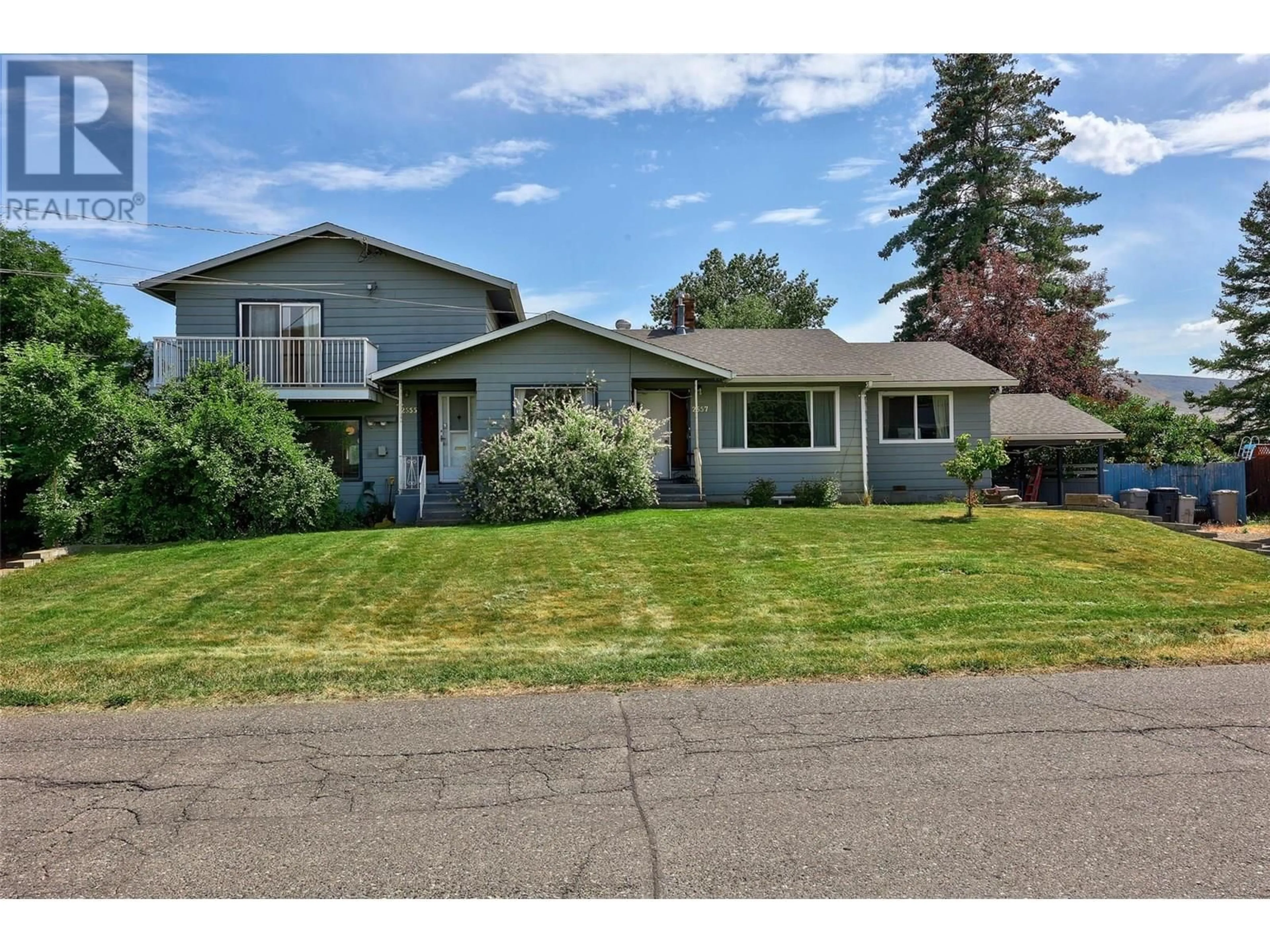 Home with vinyl exterior material, street for 2555/2557 GREENFIELD AVENUE, Kamloops British Columbia V2B4P6