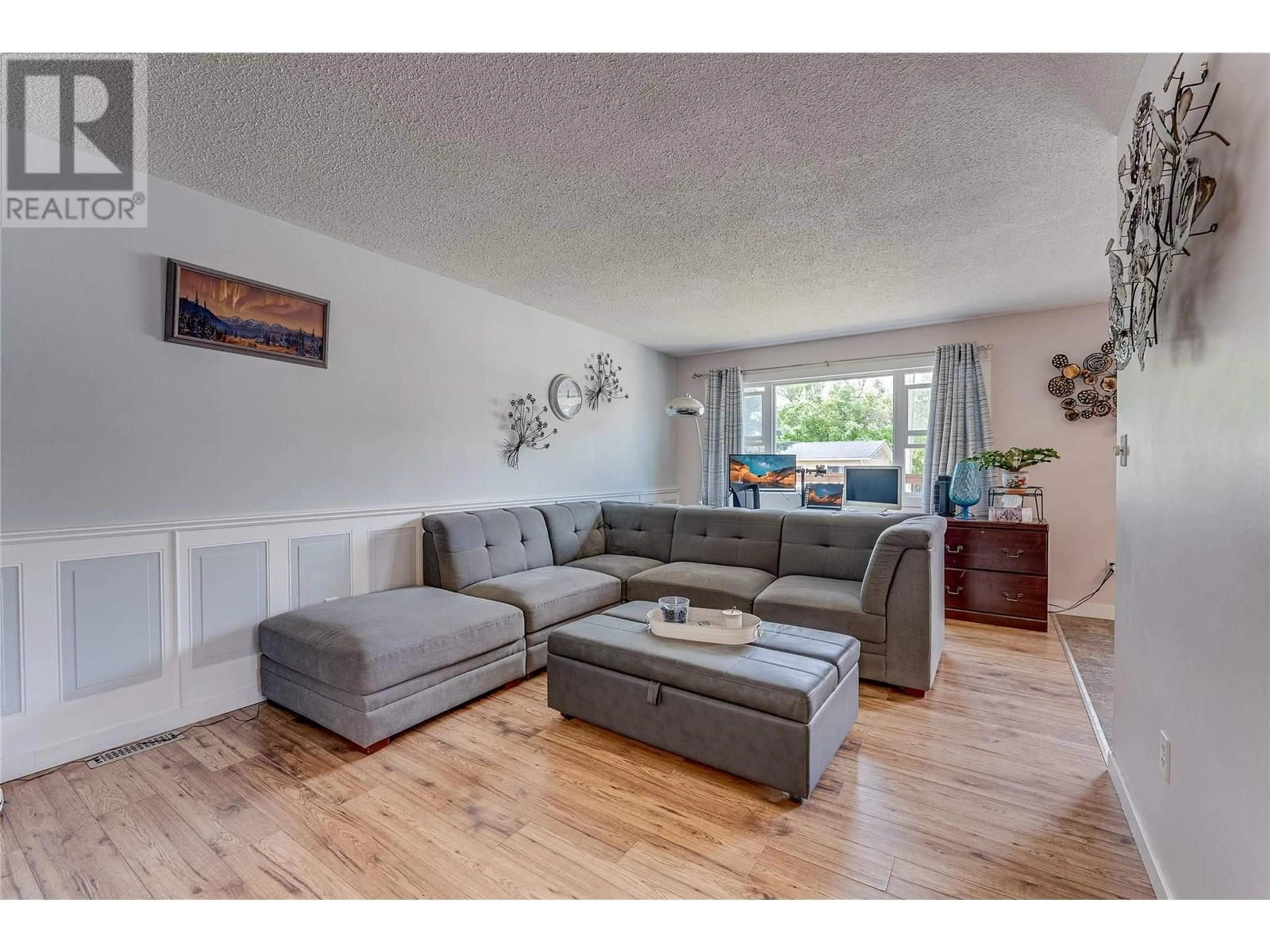 Living room with furniture, wood/laminate floor for 1603A 45 STREET, Vernon British Columbia V1T7P9
