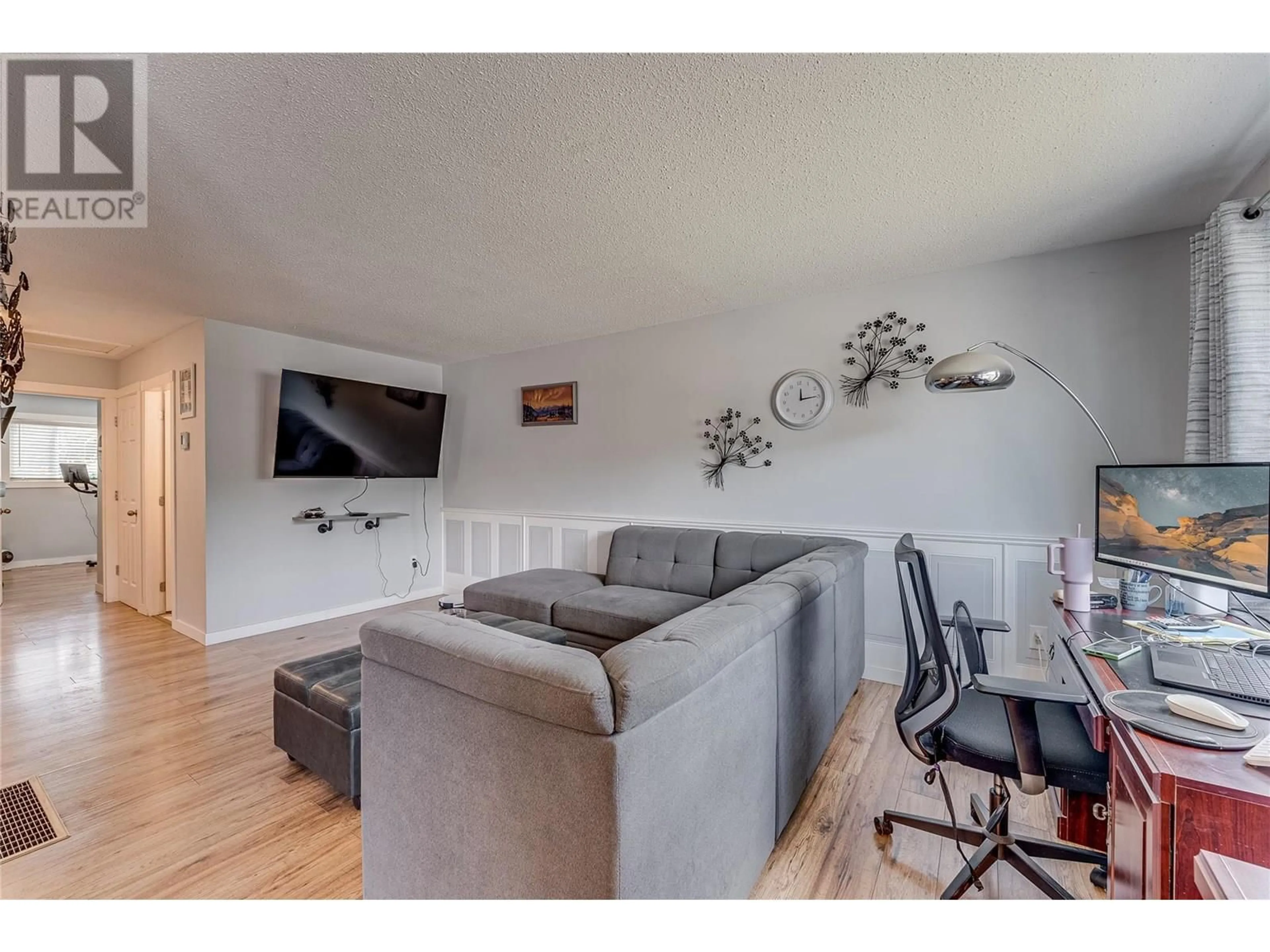 Living room with furniture, wood/laminate floor for 1603A 45 STREET, Vernon British Columbia V1T7P9