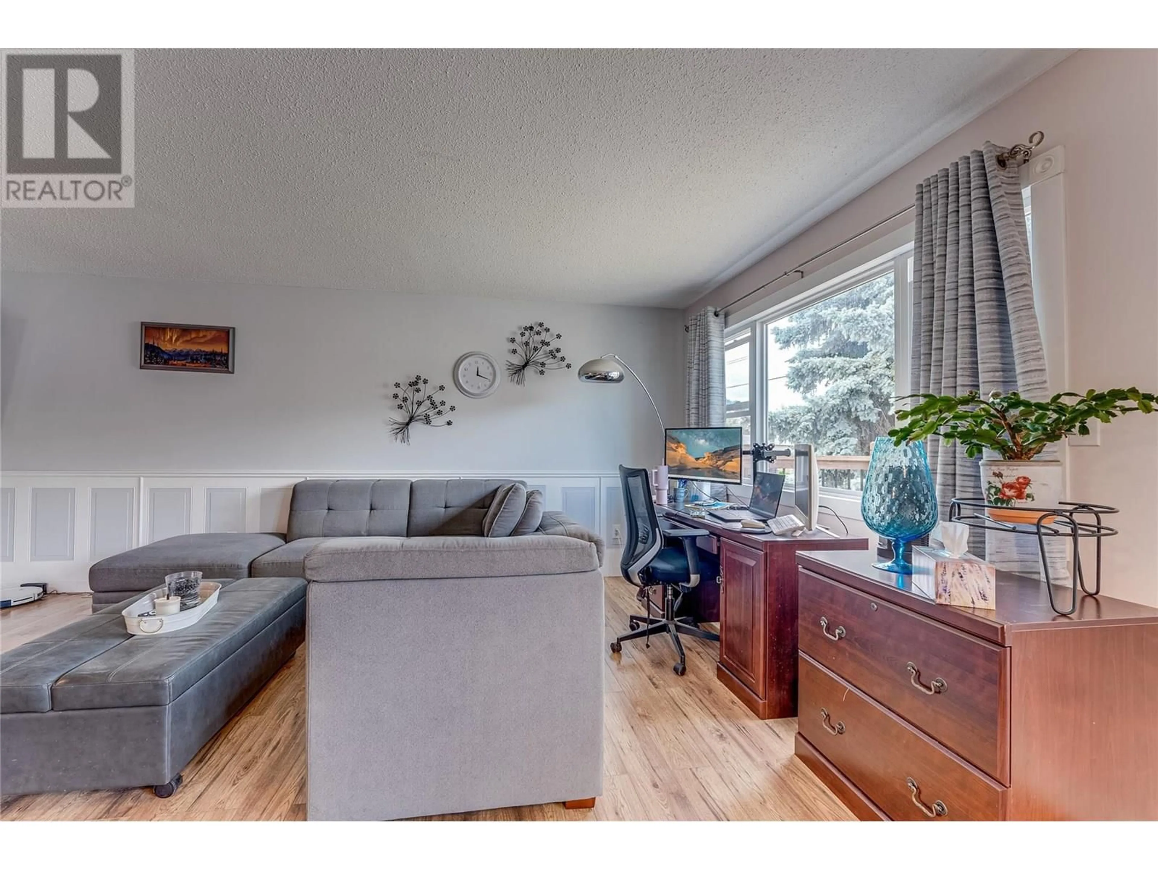Living room with furniture, wood/laminate floor for 1603A 45 STREET, Vernon British Columbia V1T7P9