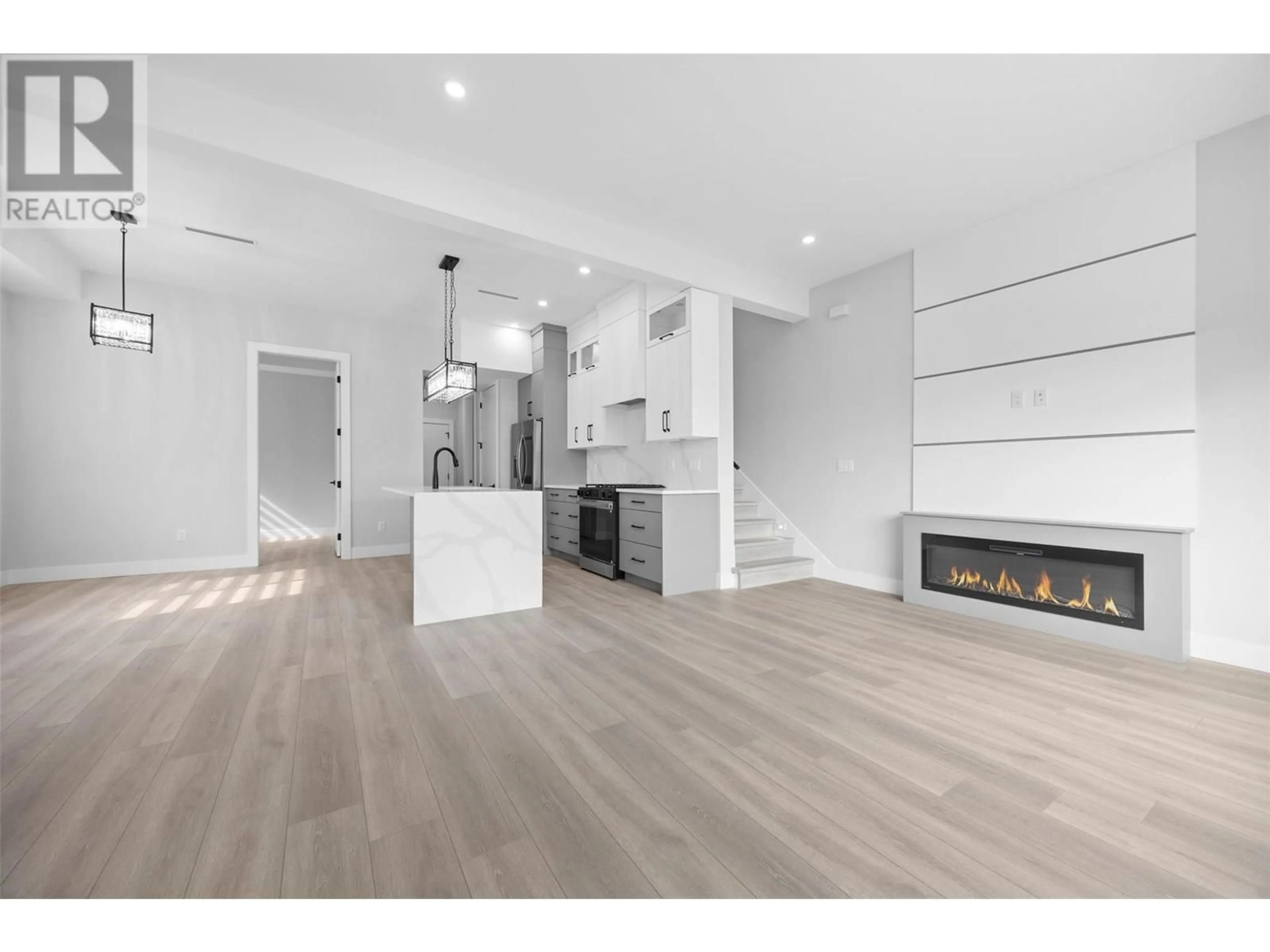 Open concept kitchen, wood/laminate floor for 1 - 954 STOCKWELL AVENUE, Kelowna British Columbia V1Y6W2