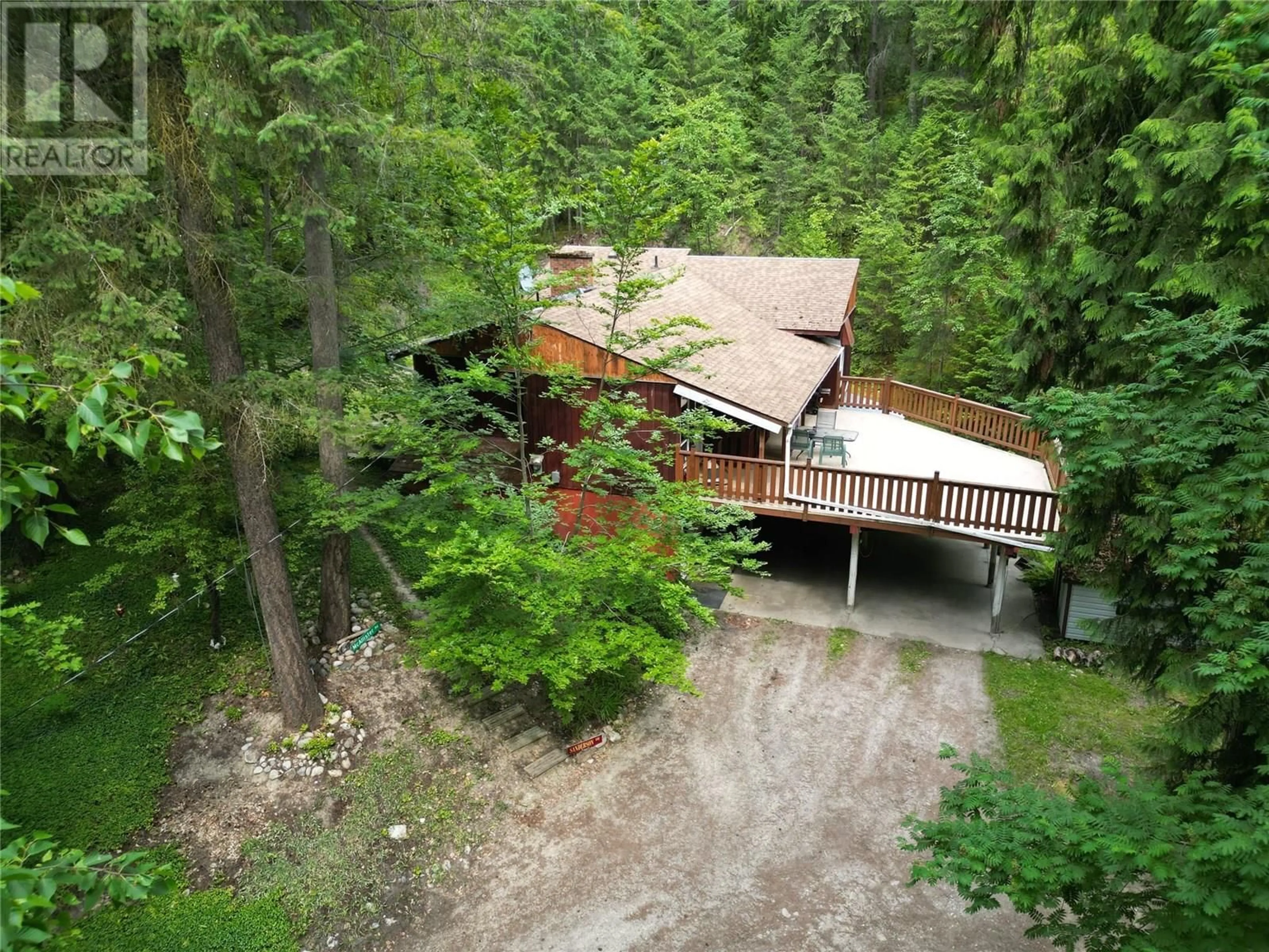 A pic from outside/outdoor area/front of a property/back of a property/a pic from drone, forest/trees view for 8043 97A HIGHWAY, Mara British Columbia V0E2K0