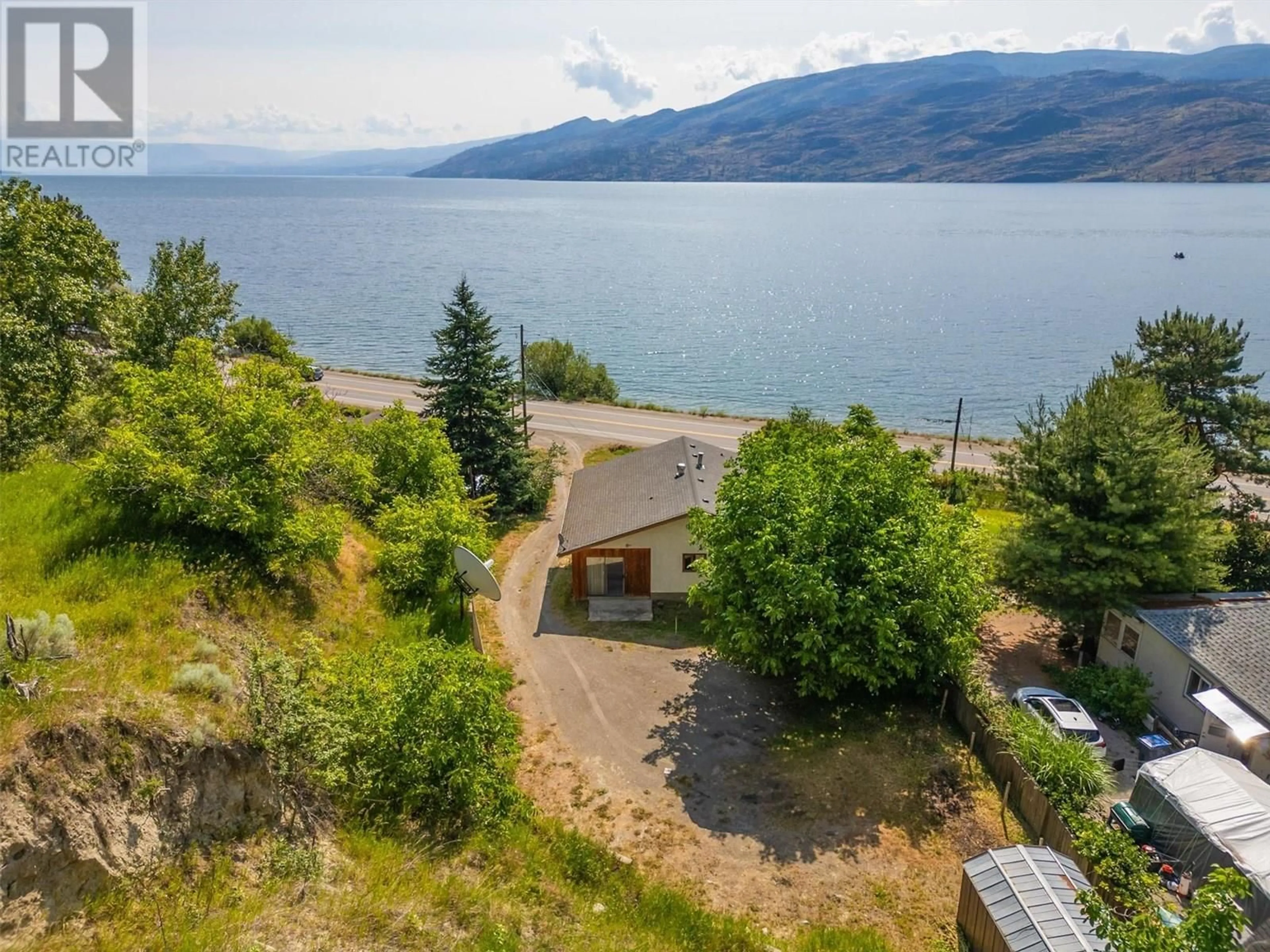 A pic from outside/outdoor area/front of a property/back of a property/a pic from drone, water/lake/river/ocean view for 6086 HIGHWAY 97 OTHER, Peachland British Columbia V0H1X7
