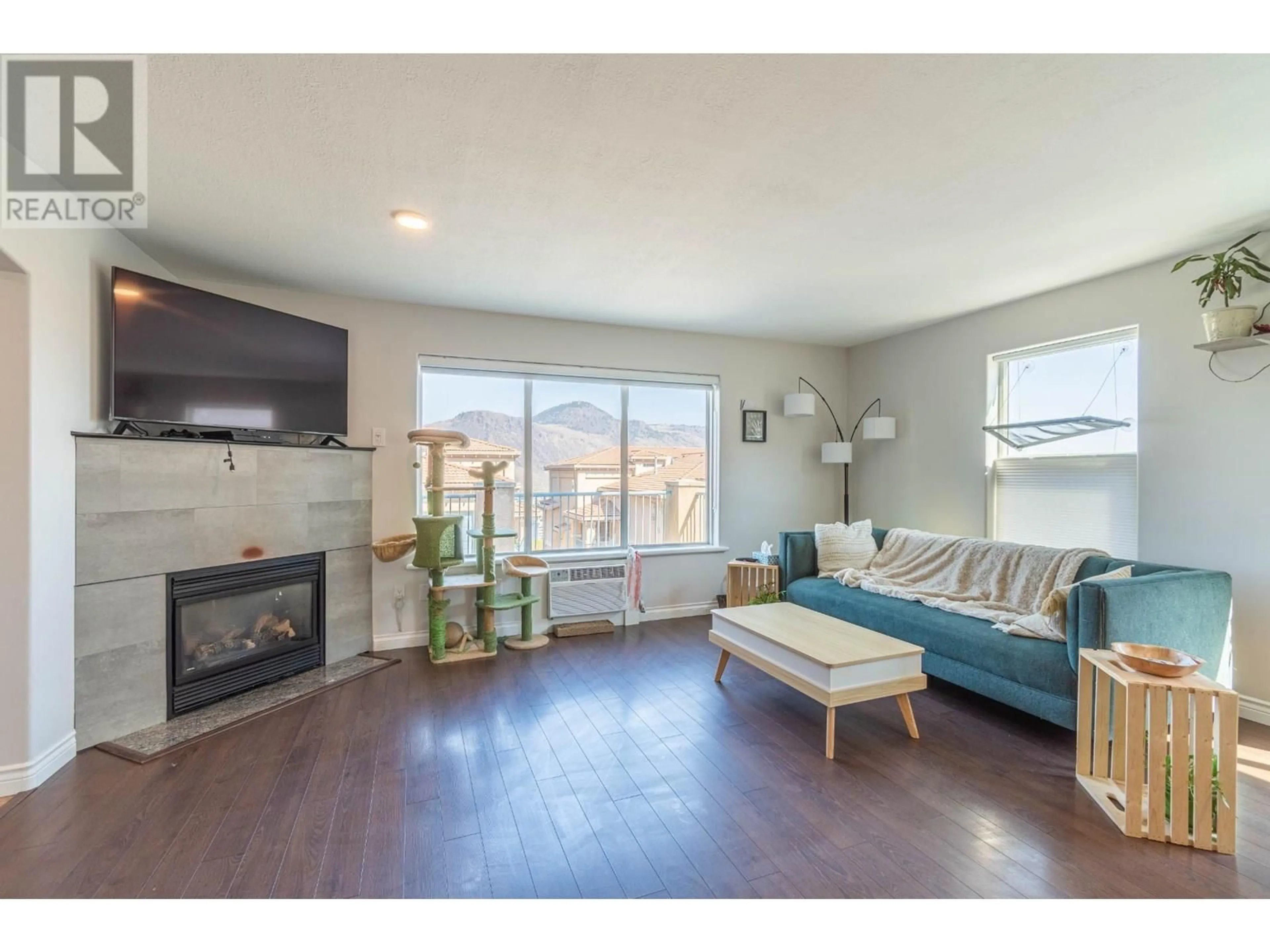 Living room with furniture, wood/laminate floor for 204 - 875 SAHALI TERRACE, Kamloops British Columbia V2C6W8