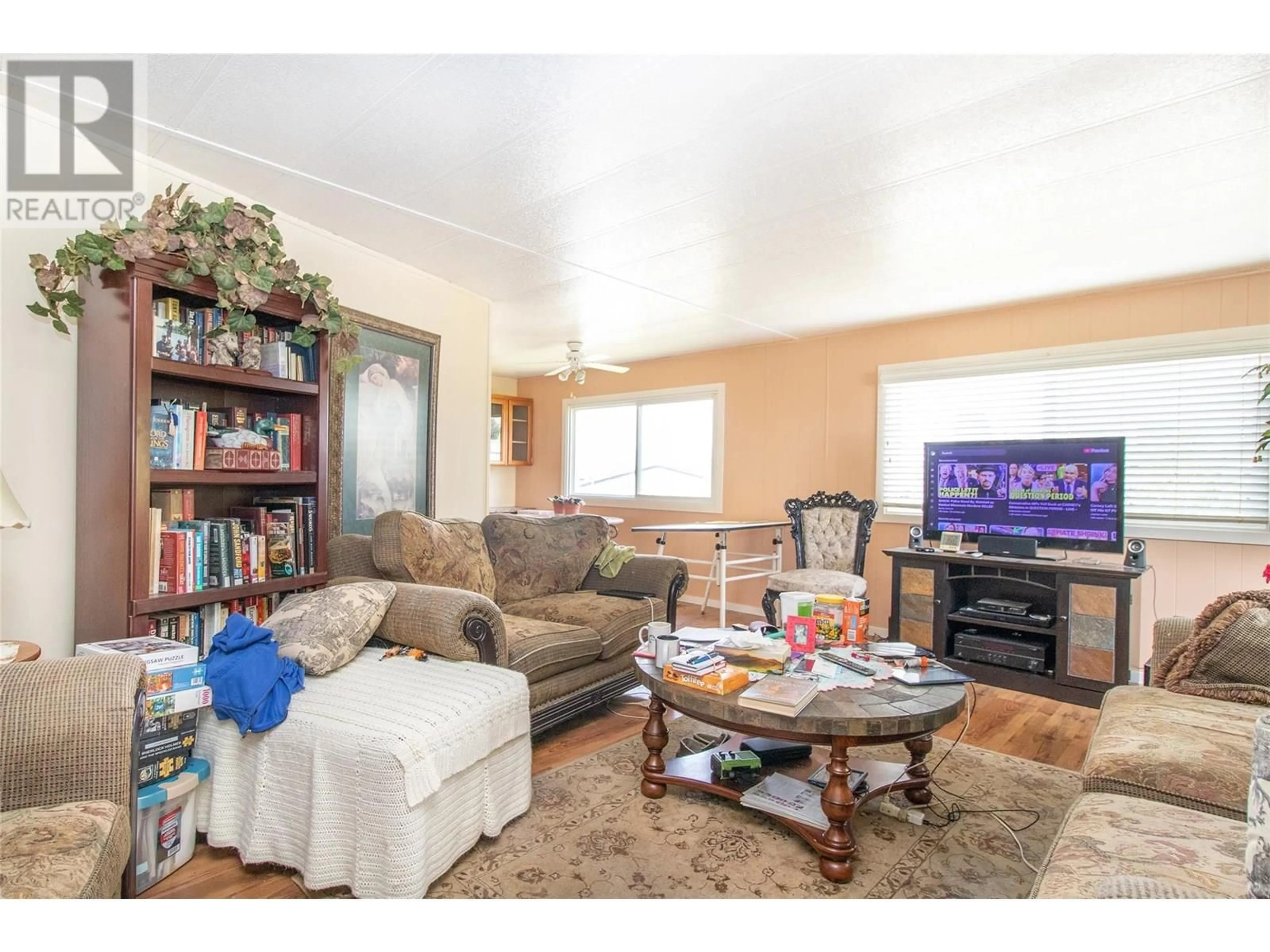 Living room with furniture, wood/laminate floor for 215 - 3591 OLD VERNON ROAD, Kelowna British Columbia V1X6P4