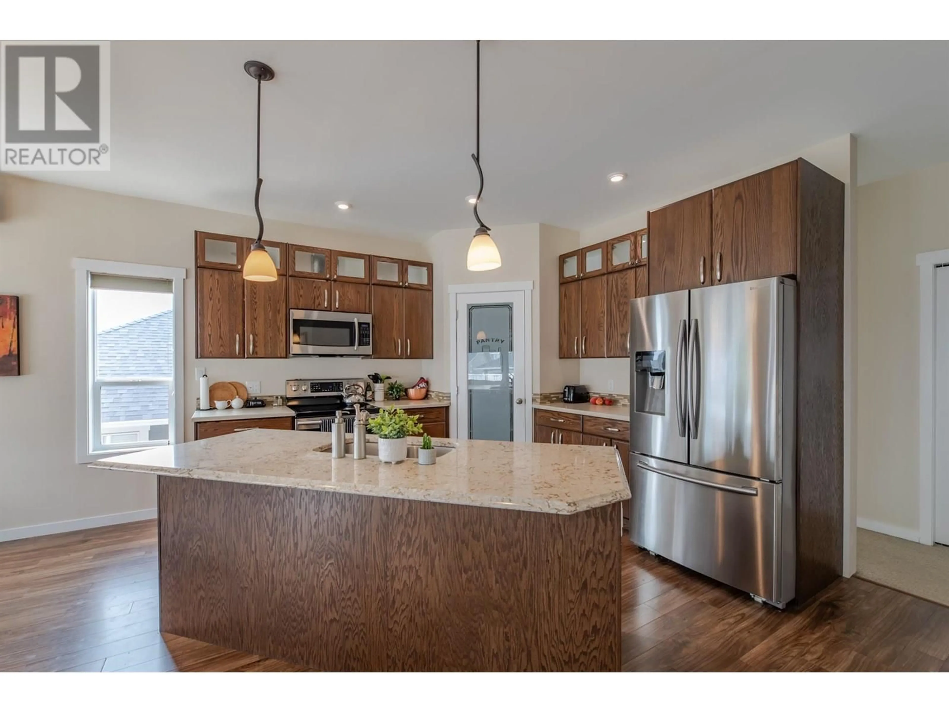 Open concept kitchen, wood/laminate floor for 2126 LAWRENCE AVENUE, Penticton British Columbia V2A9G5
