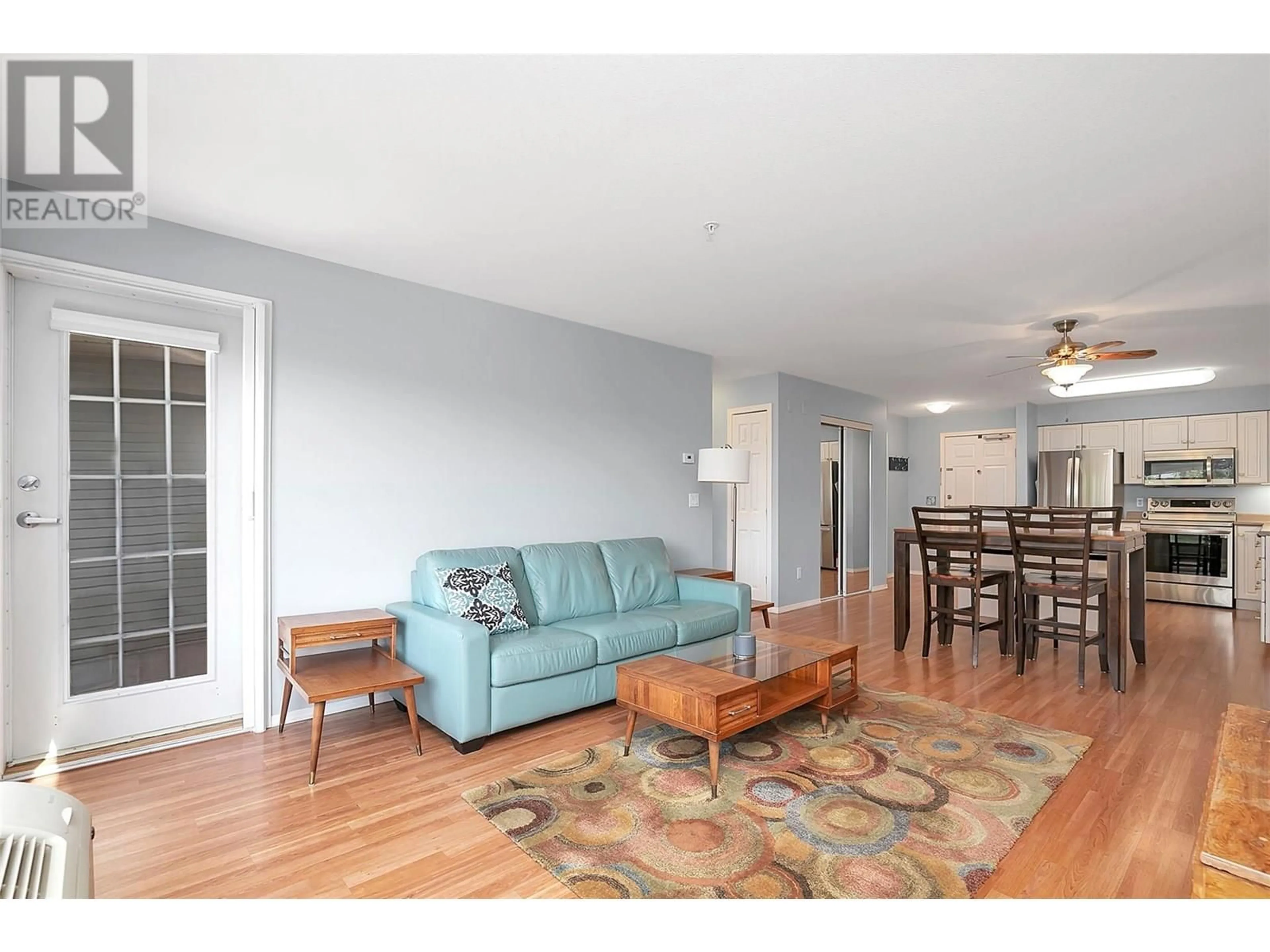 Living room with furniture, wood/laminate floor for 306 - 265 FROELICH ROAD, Kelowna British Columbia V1X3M6