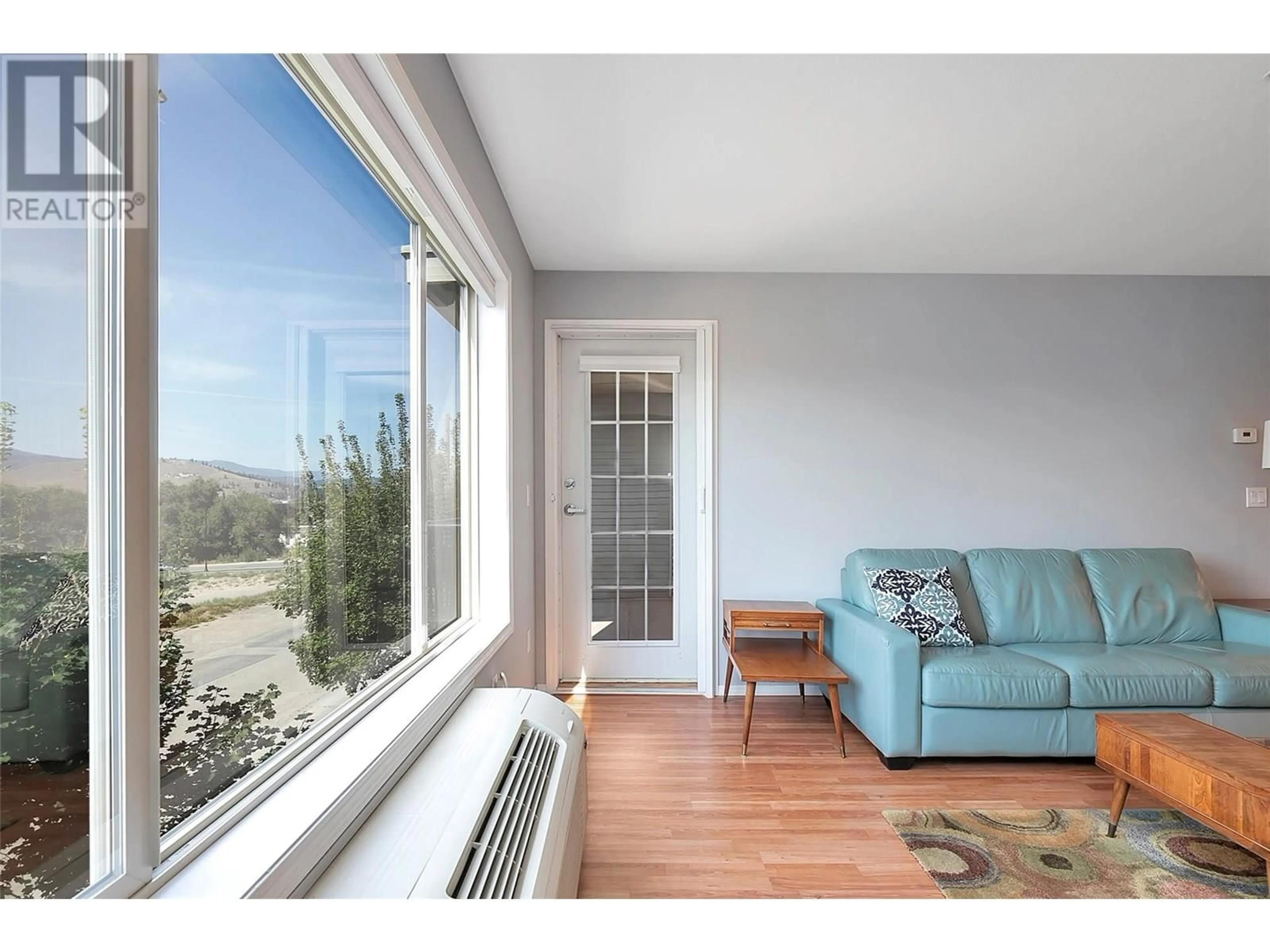 Living room with furniture, wood/laminate floor for 306 - 265 FROELICH ROAD, Kelowna British Columbia V1X3M6