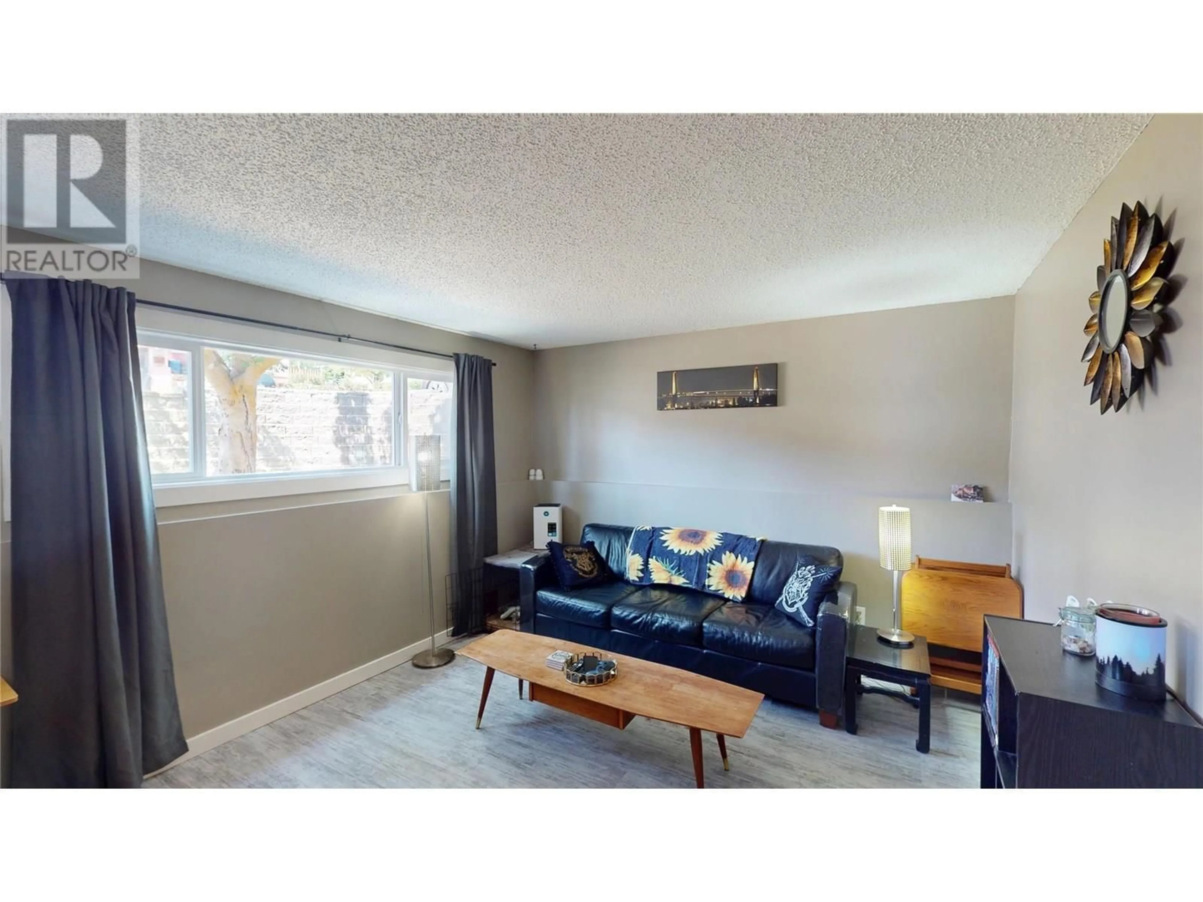Living room with furniture, wood/laminate floor for A - 717 6TH AVENUE, Kimberley British Columbia V1A2V9