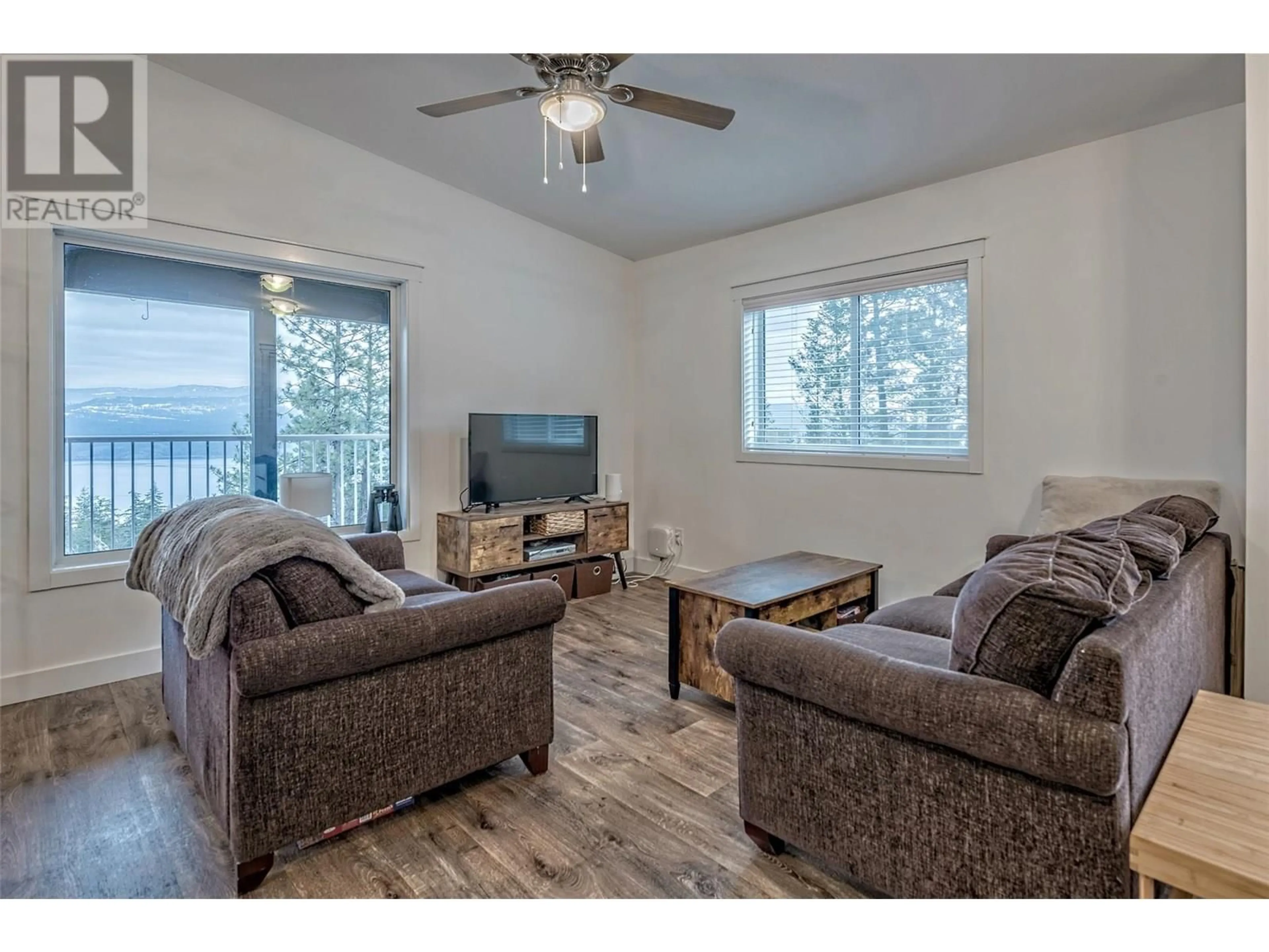 Living room with furniture, wood/laminate floor for 9369 KEITHLEY ROAD, Vernon British Columbia V1H2C8