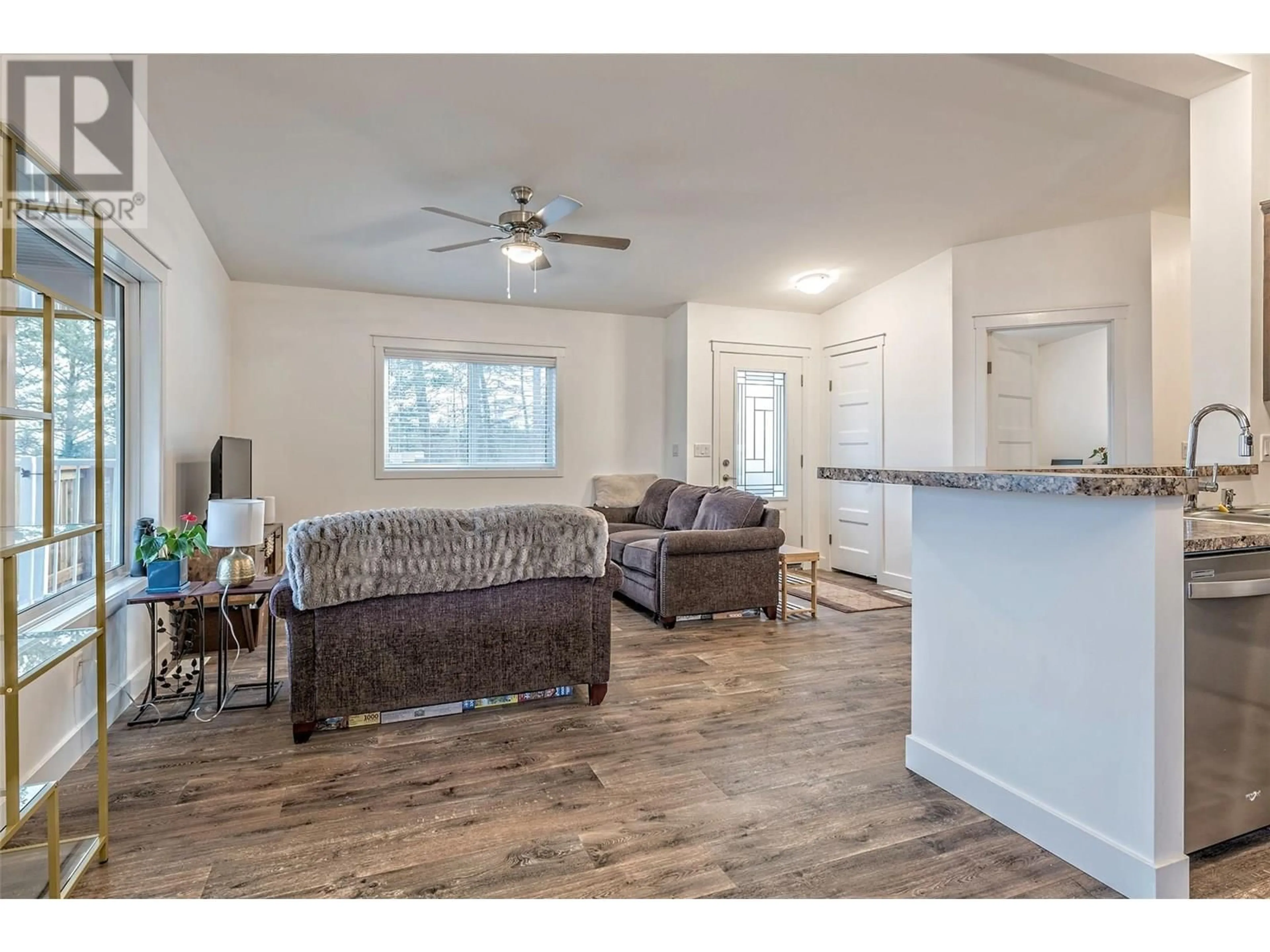 Living room with furniture, wood/laminate floor for 9369 KEITHLEY ROAD, Vernon British Columbia V1H2C8