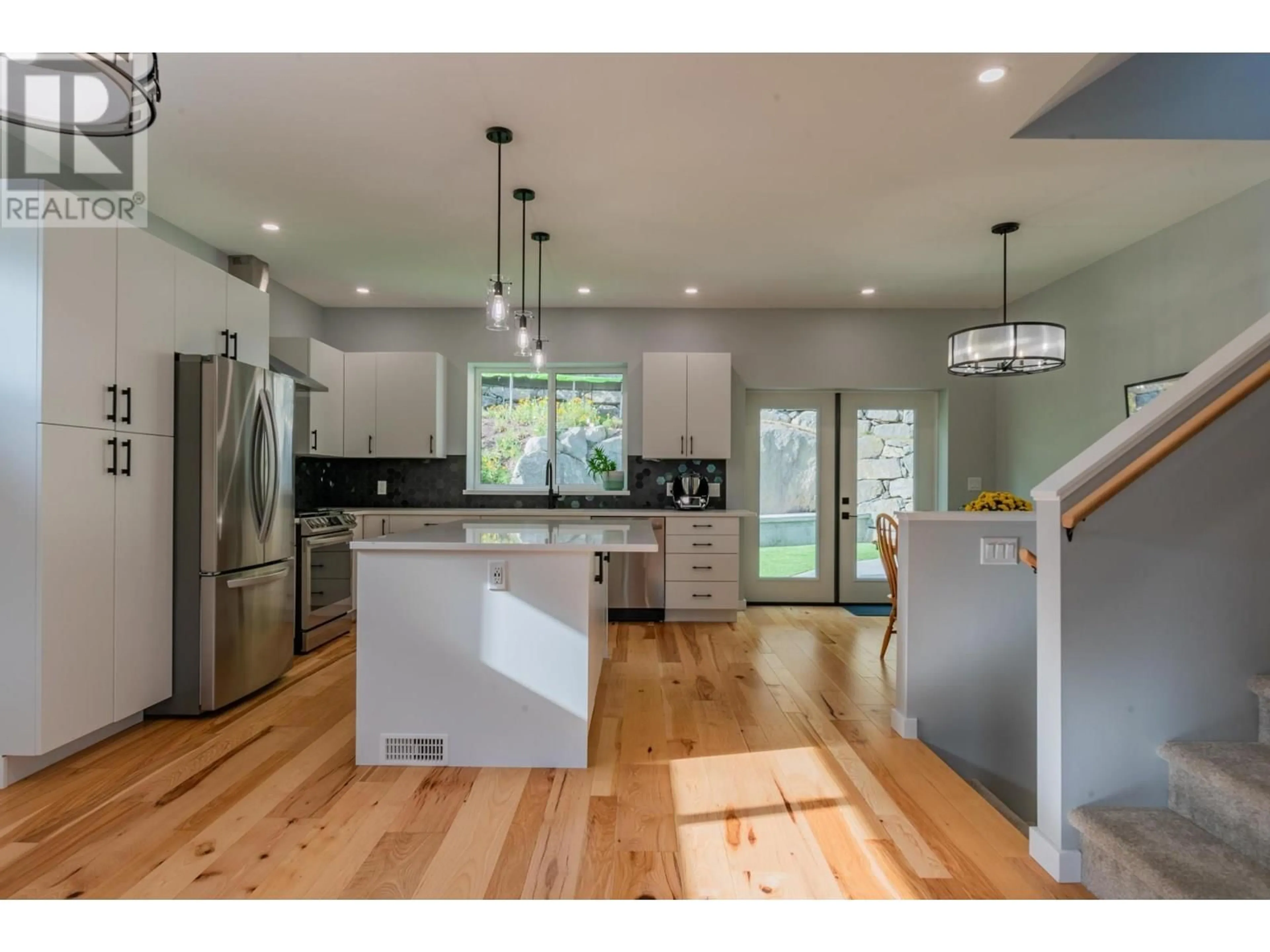 Open concept kitchen, wood/laminate floor for 934 REDSTONE DRIVE, Rossland British Columbia V0G1Y0