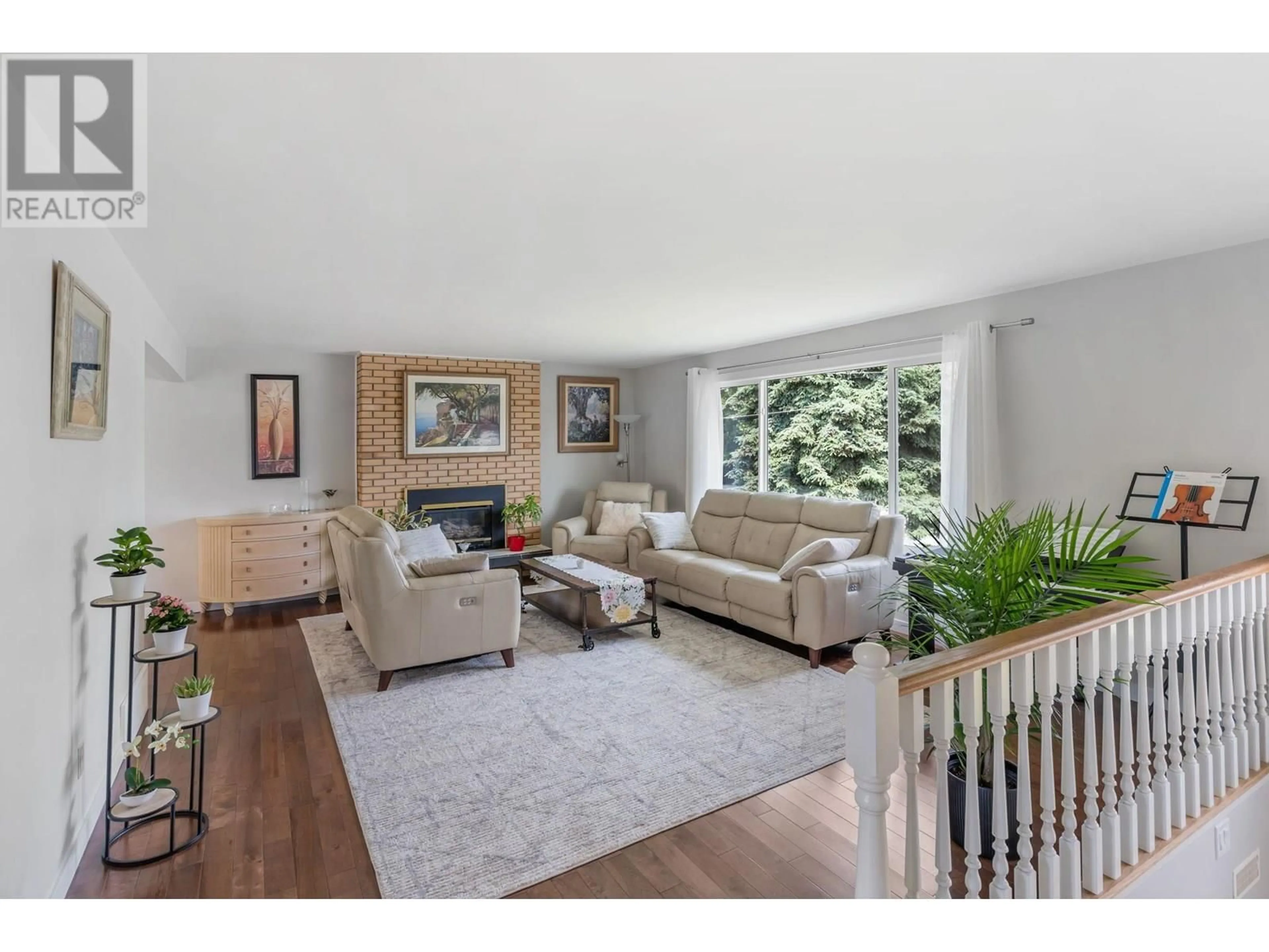 Living room with furniture, wood/laminate floor for 449 BARKLEY ROAD, Kelowna British Columbia V1W1E4