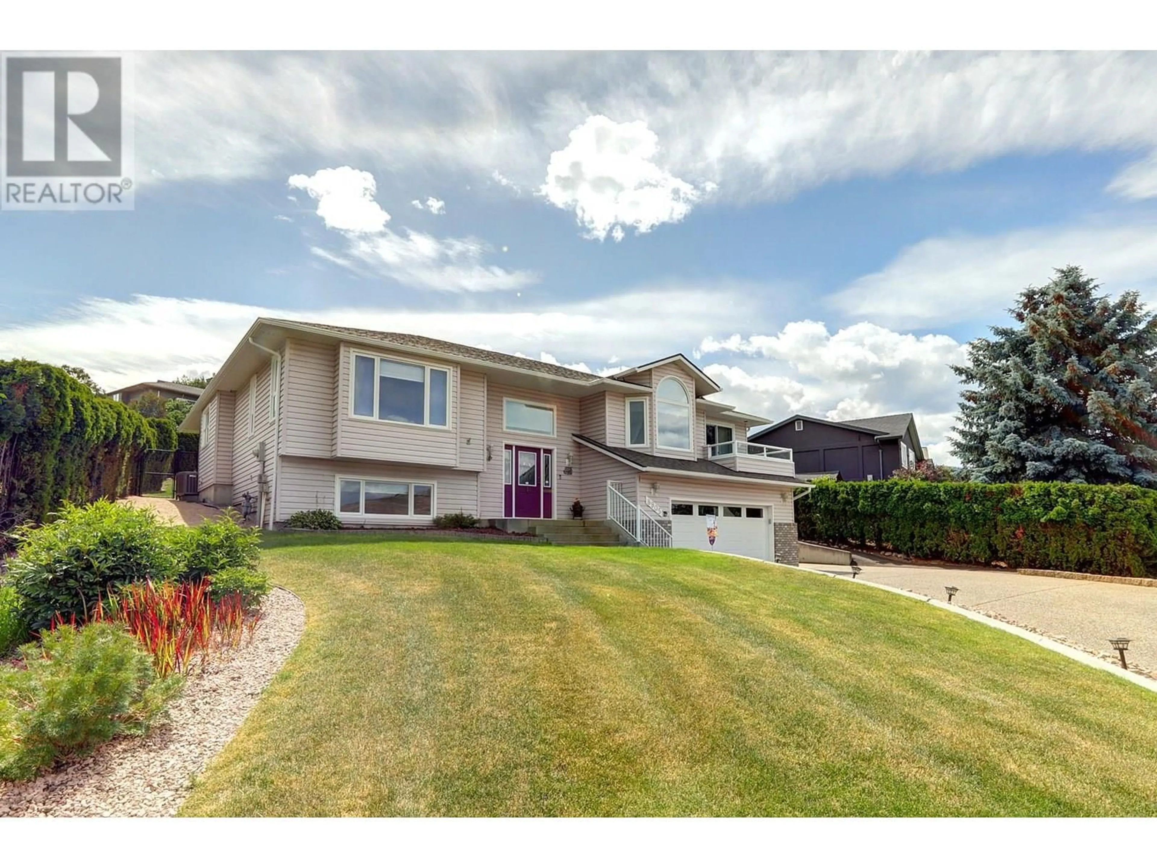 Home with vinyl exterior material, street for 8905 ORCHARD RIDGE DRIVE, Coldstream British Columbia V1B1Z7