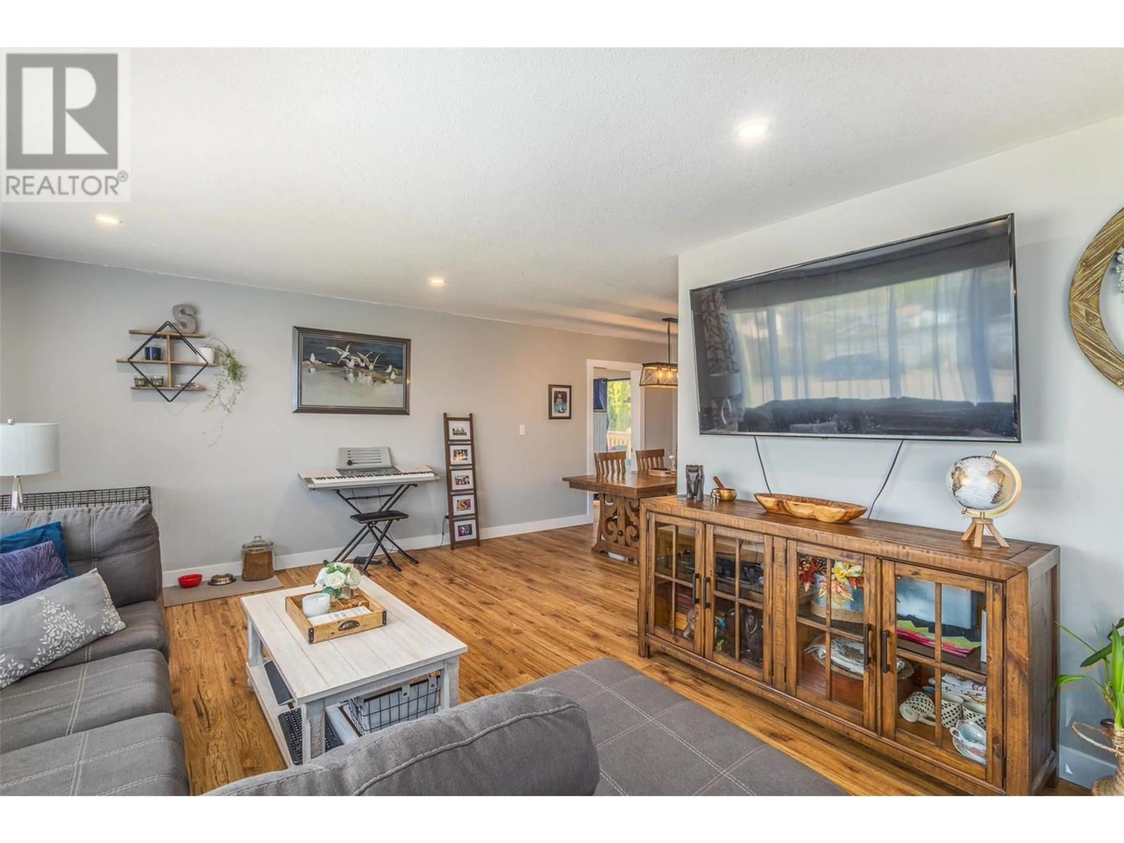 Living room with furniture, wood/laminate floor for 3339 BOTHE ROAD, Kelowna British Columbia V1W3M3