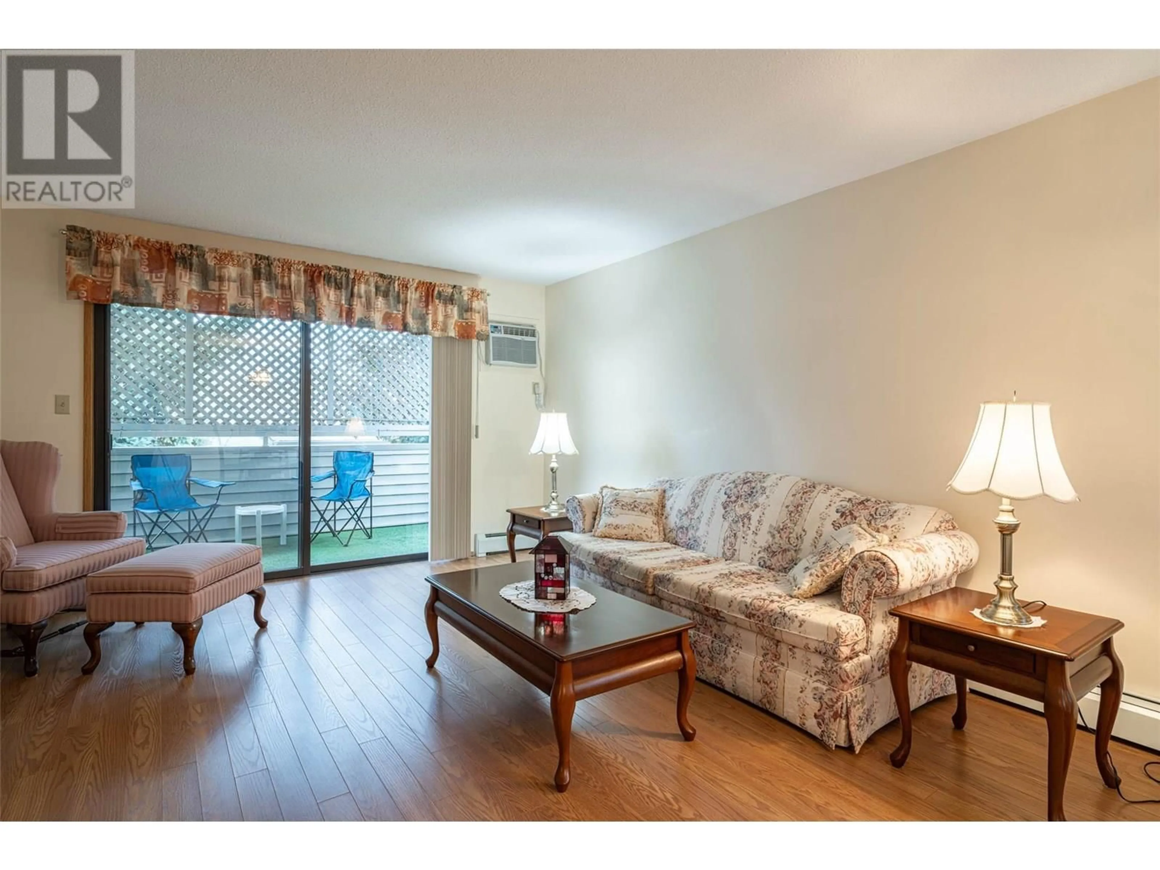 Living room with furniture, wood/laminate floor for 212 - 3608 27 AVENUE, Vernon British Columbia V1T1S4
