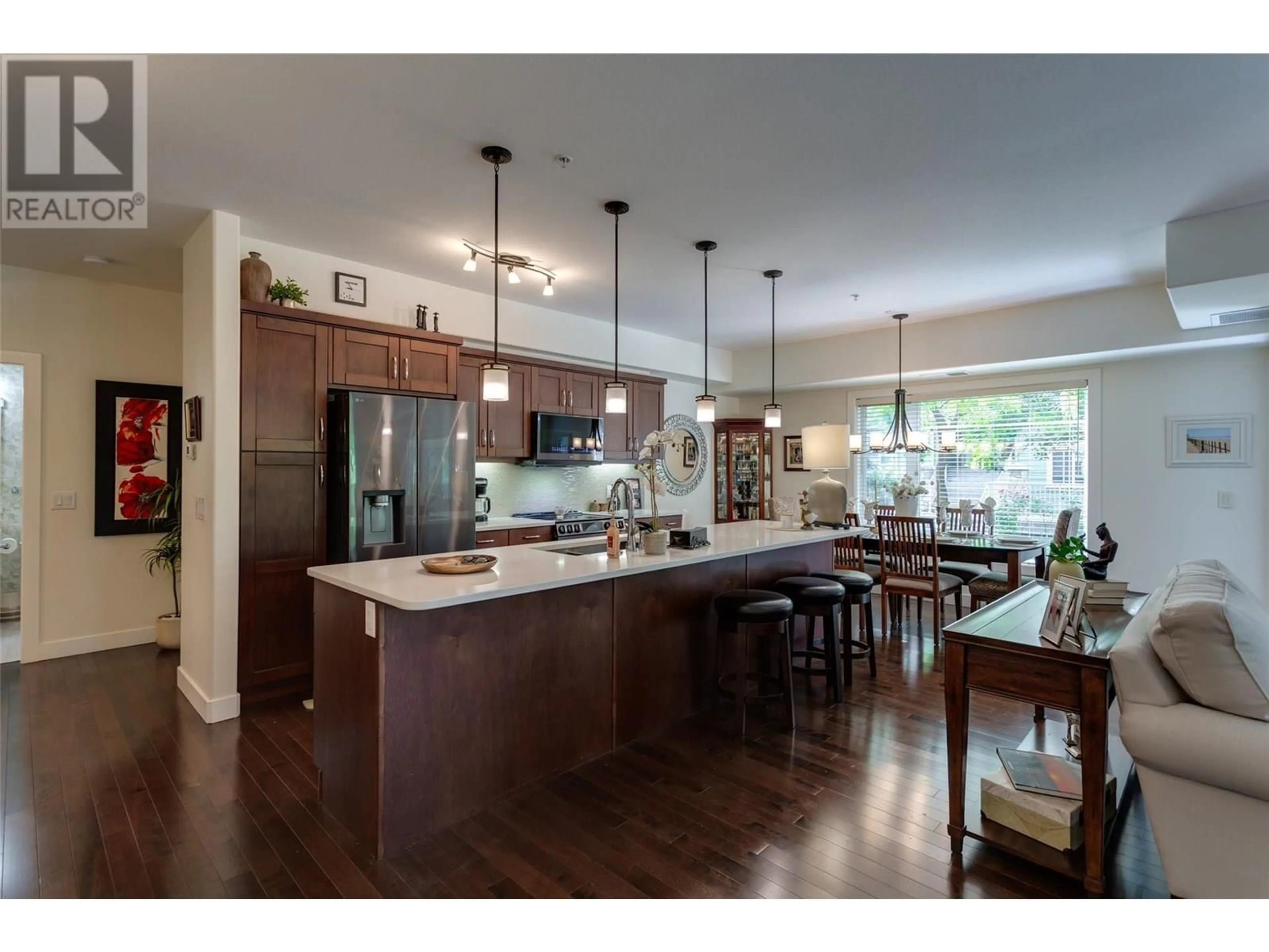 Open concept kitchen, wood/laminate floor for 102 - 660 LEQUIME ROAD, Kelowna British Columbia V1W1A4