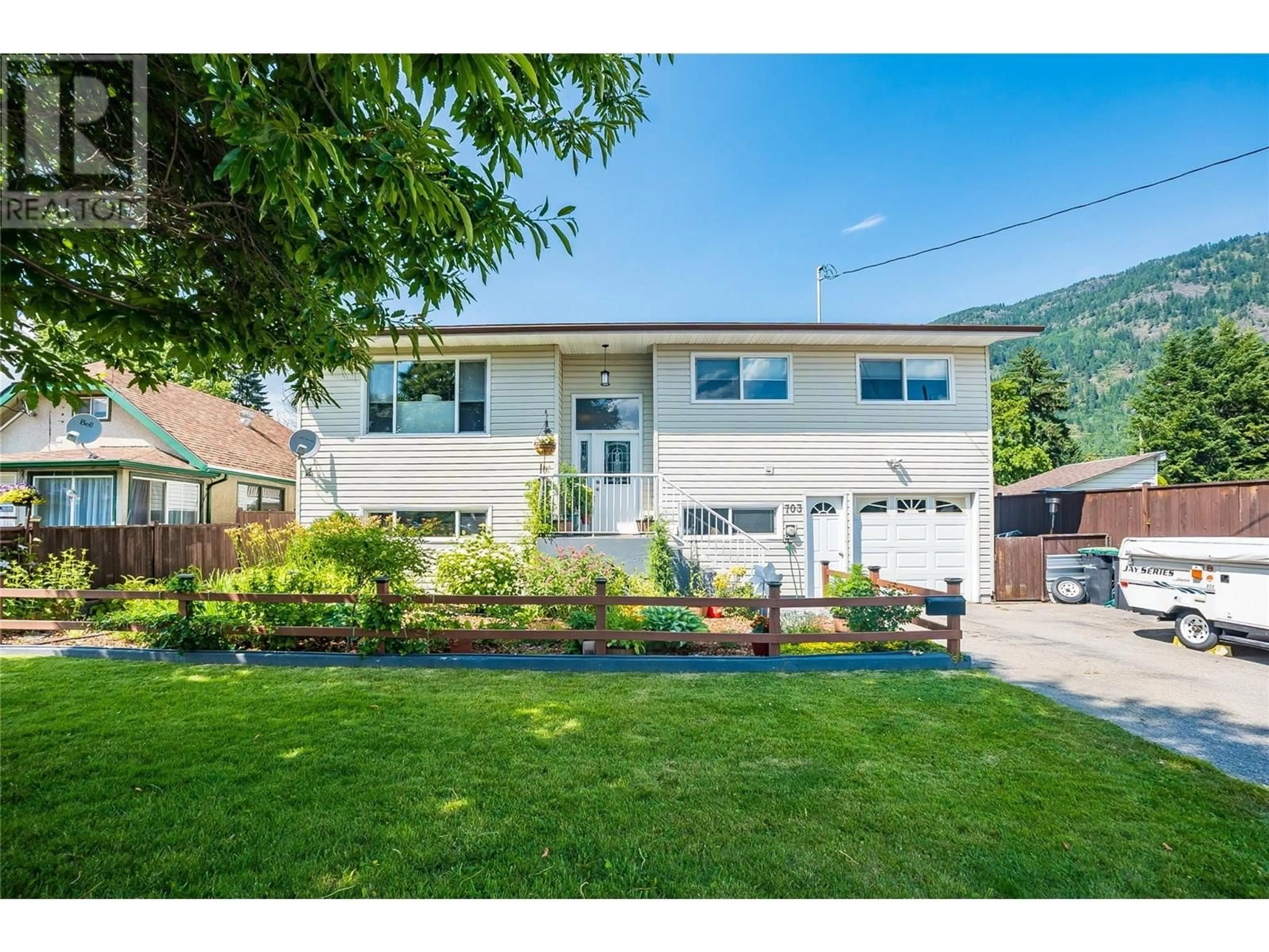 Home with vinyl exterior material, street for 703 2ND STREET, Castlegar British Columbia V1N1Y9