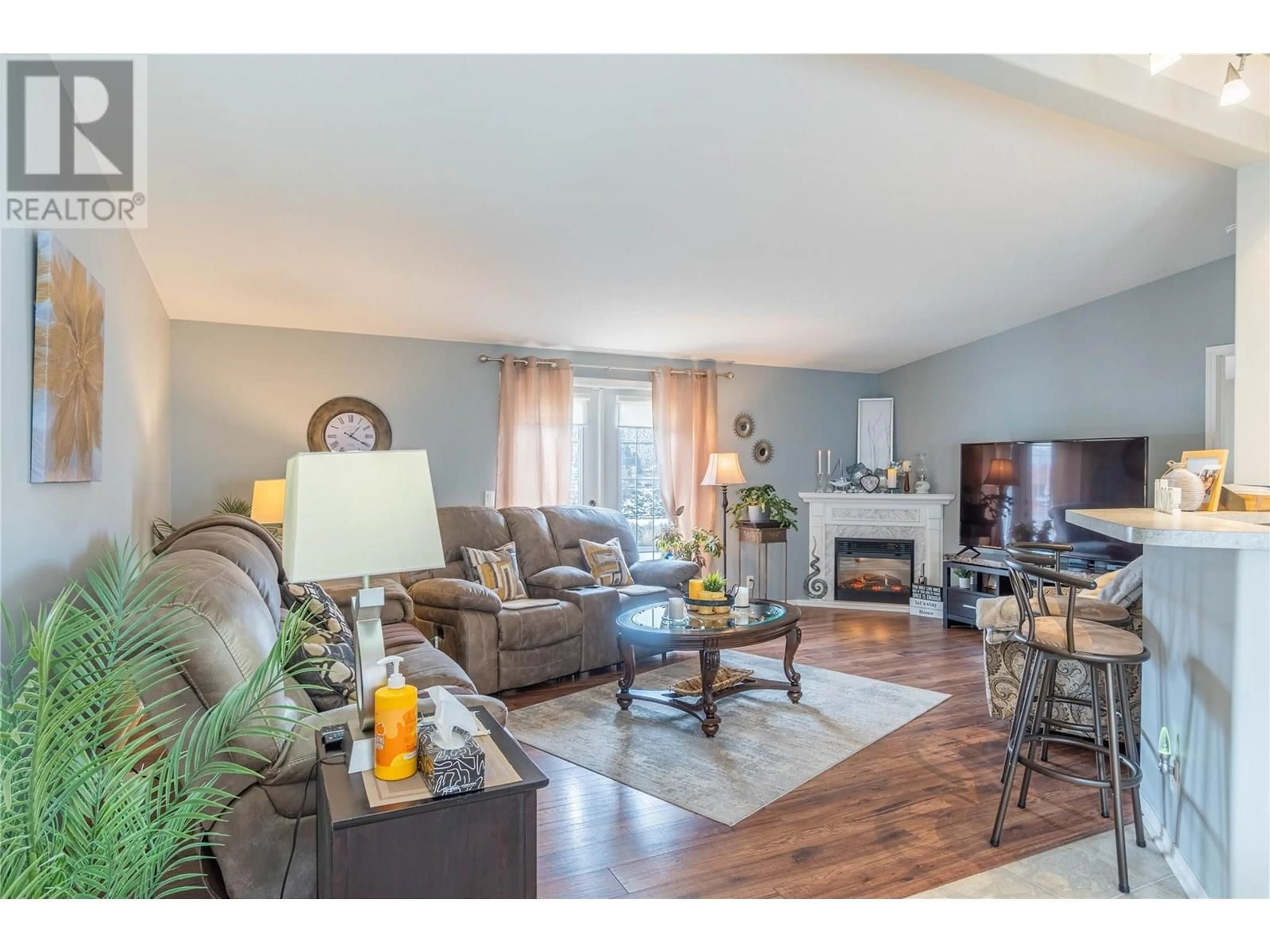 Living room with furniture, wood/laminate floor for 1 - 768 SHUSWAP ROAD EAST, Kamloops British Columbia V2H0A4