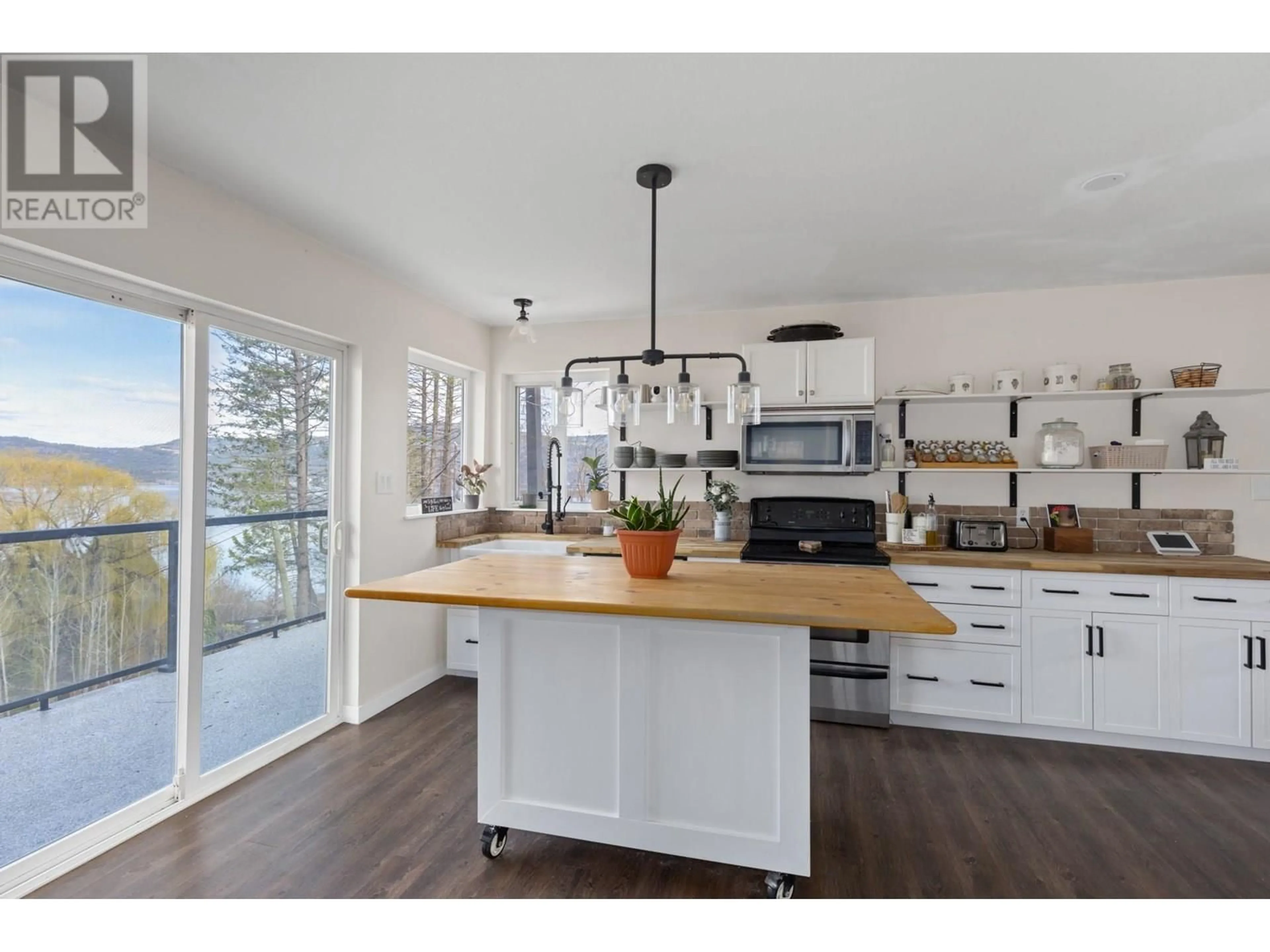 Open concept kitchen, wood/laminate floor for 50 KENYON ROAD, Vernon British Columbia V1H2E4
