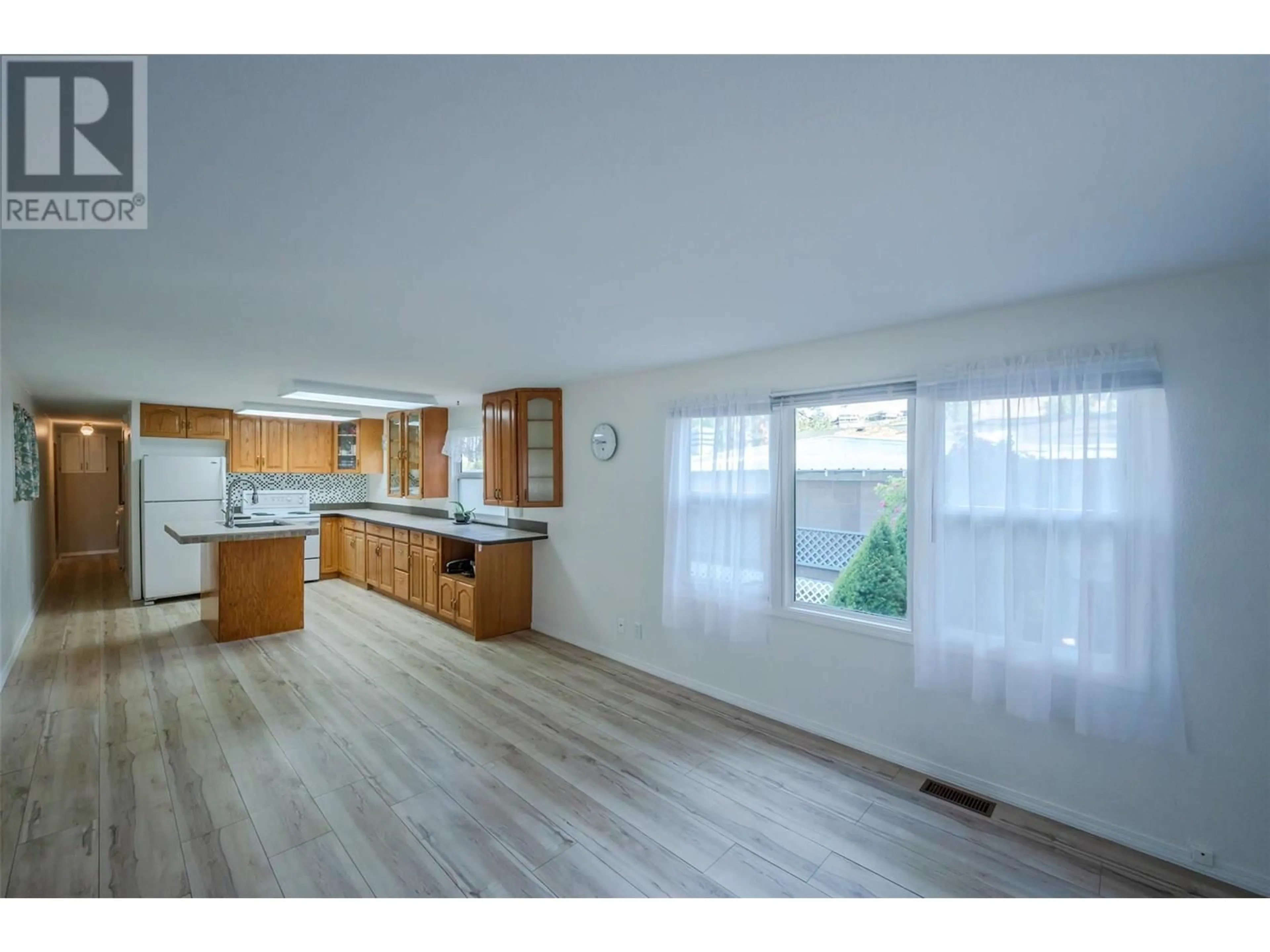Open concept kitchen, wood/laminate floor for E8 - 4505 MCLEAN CREEK ROAD, Okanagan Falls British Columbia V0H1R1