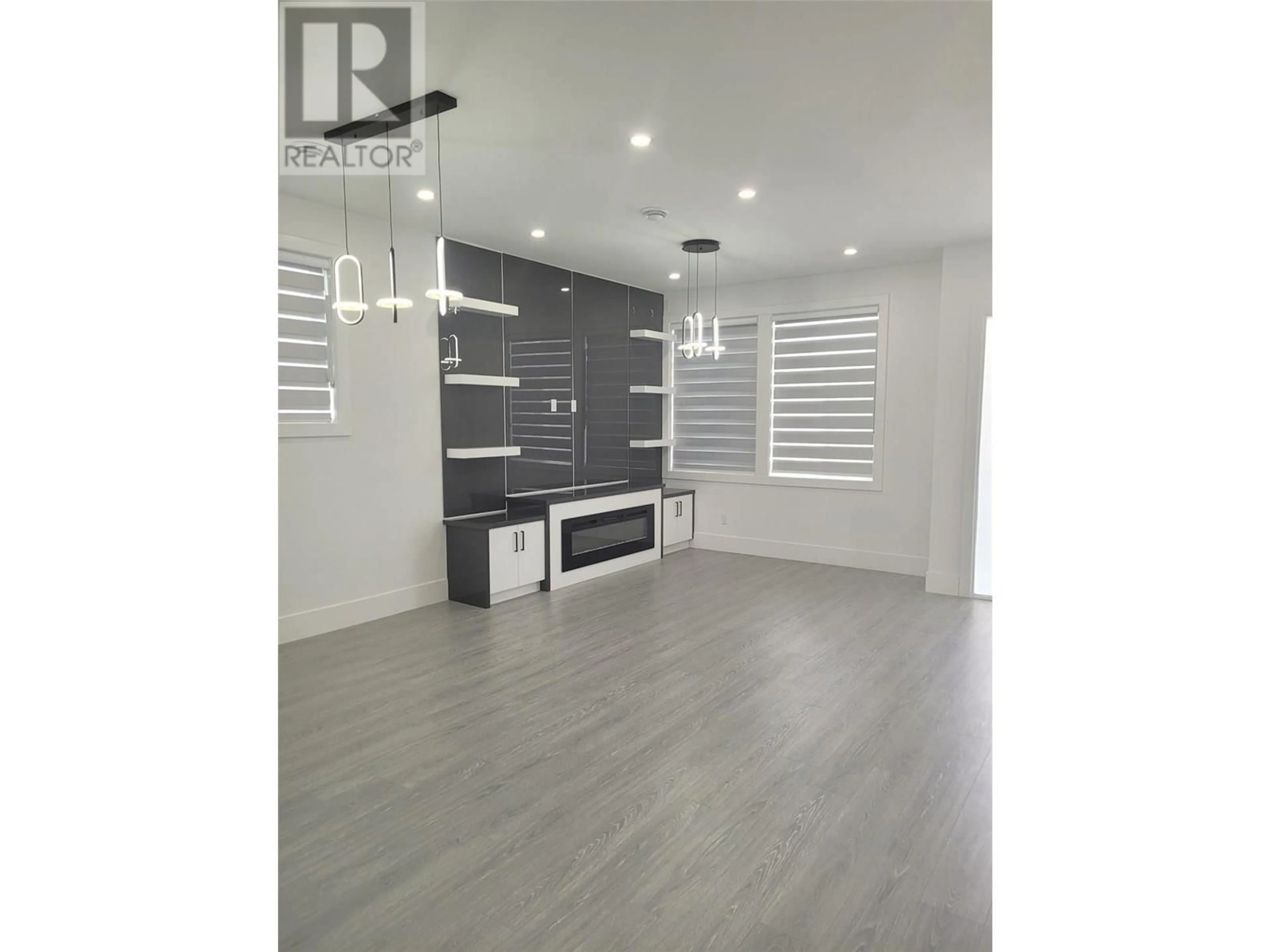 Open concept kitchen, wood/laminate floor for 1720 TREFFRY PLACE, Summerland British Columbia V0H1Z9