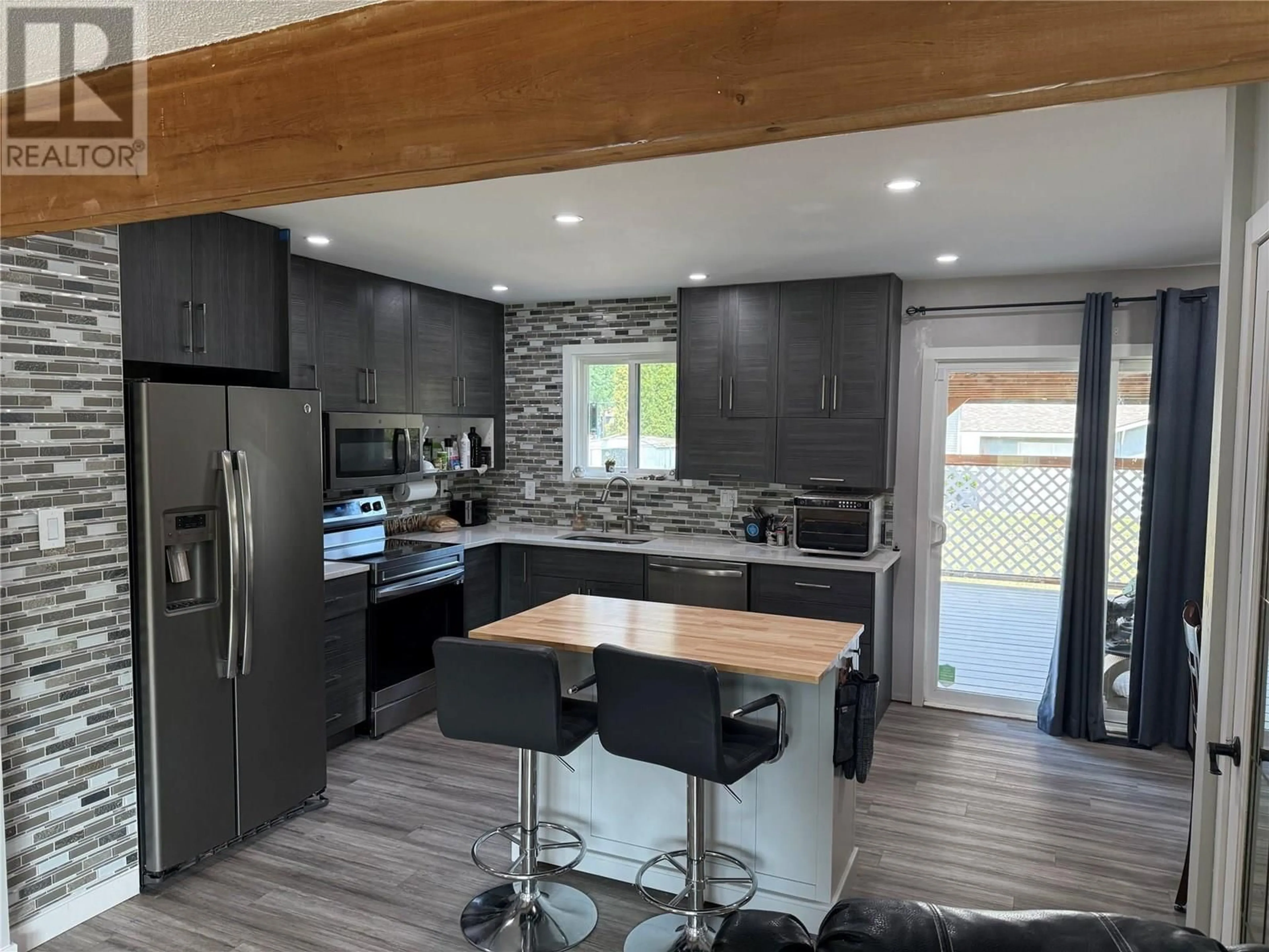 Open concept kitchen, wood/laminate floor for 4596 CAMMERAY DRIVE, Kamloops British Columbia V2H1L4