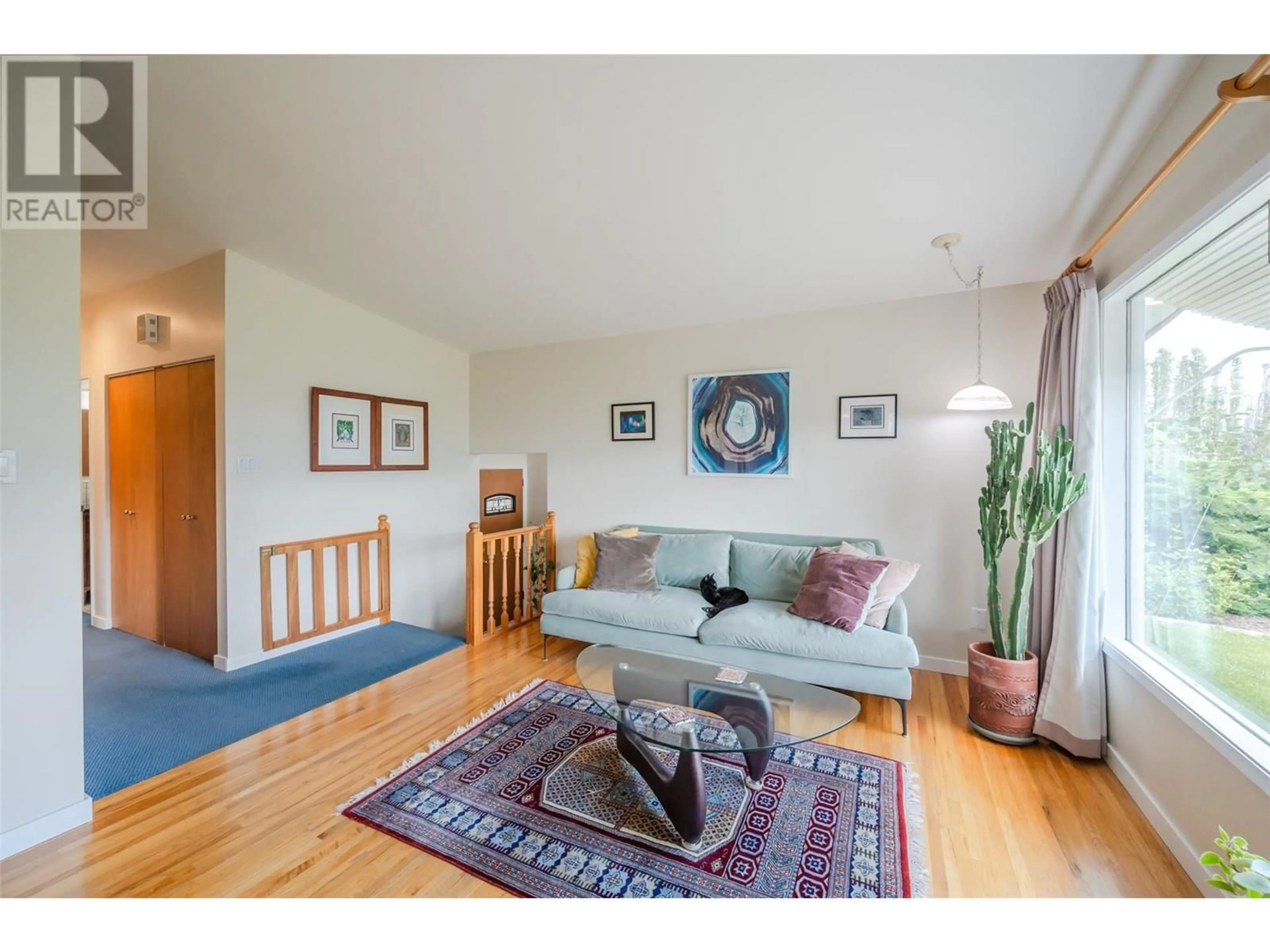 Living room with furniture, wood/laminate floor for 13807 LATIMER AVENUE, Summerland British Columbia V0H1Z1