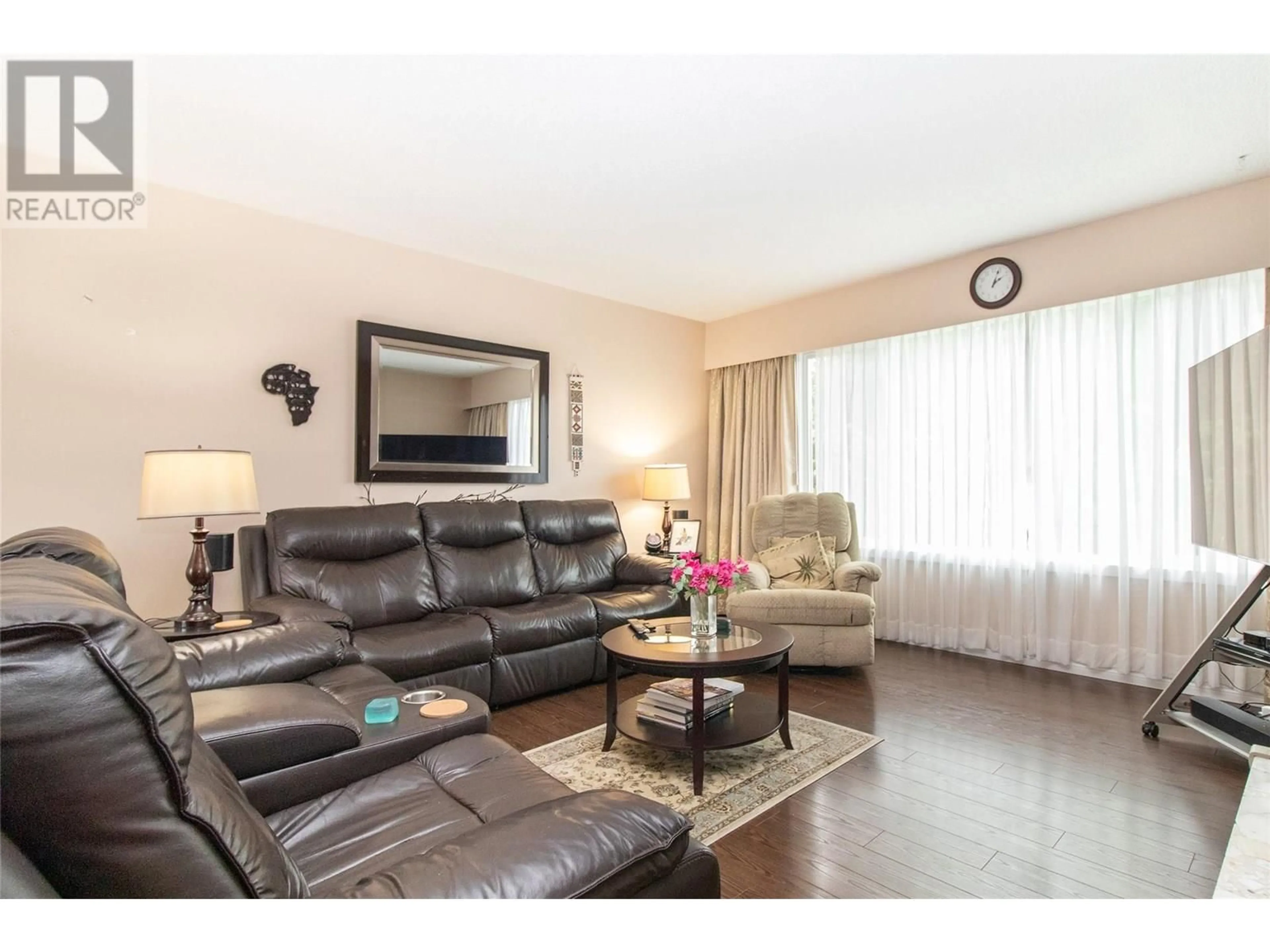 Living room with furniture, wood/laminate floor for 710 TAMARACK DRIVE, Kelowna British Columbia V1X5L9