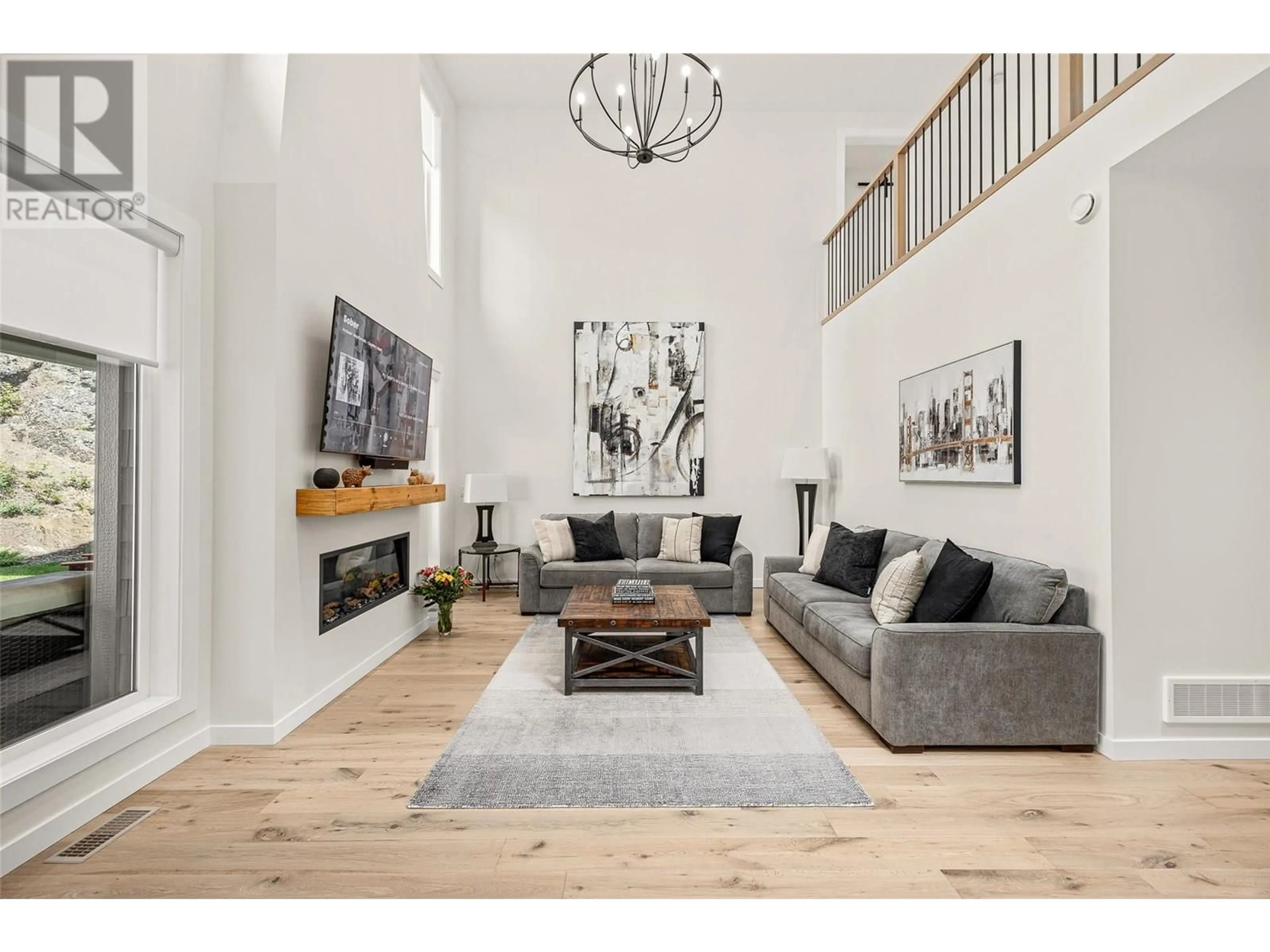 Living room with furniture, wood/laminate floor for 162 ECHO RIDGE DRIVE, Kelowna British Columbia V1V0C9
