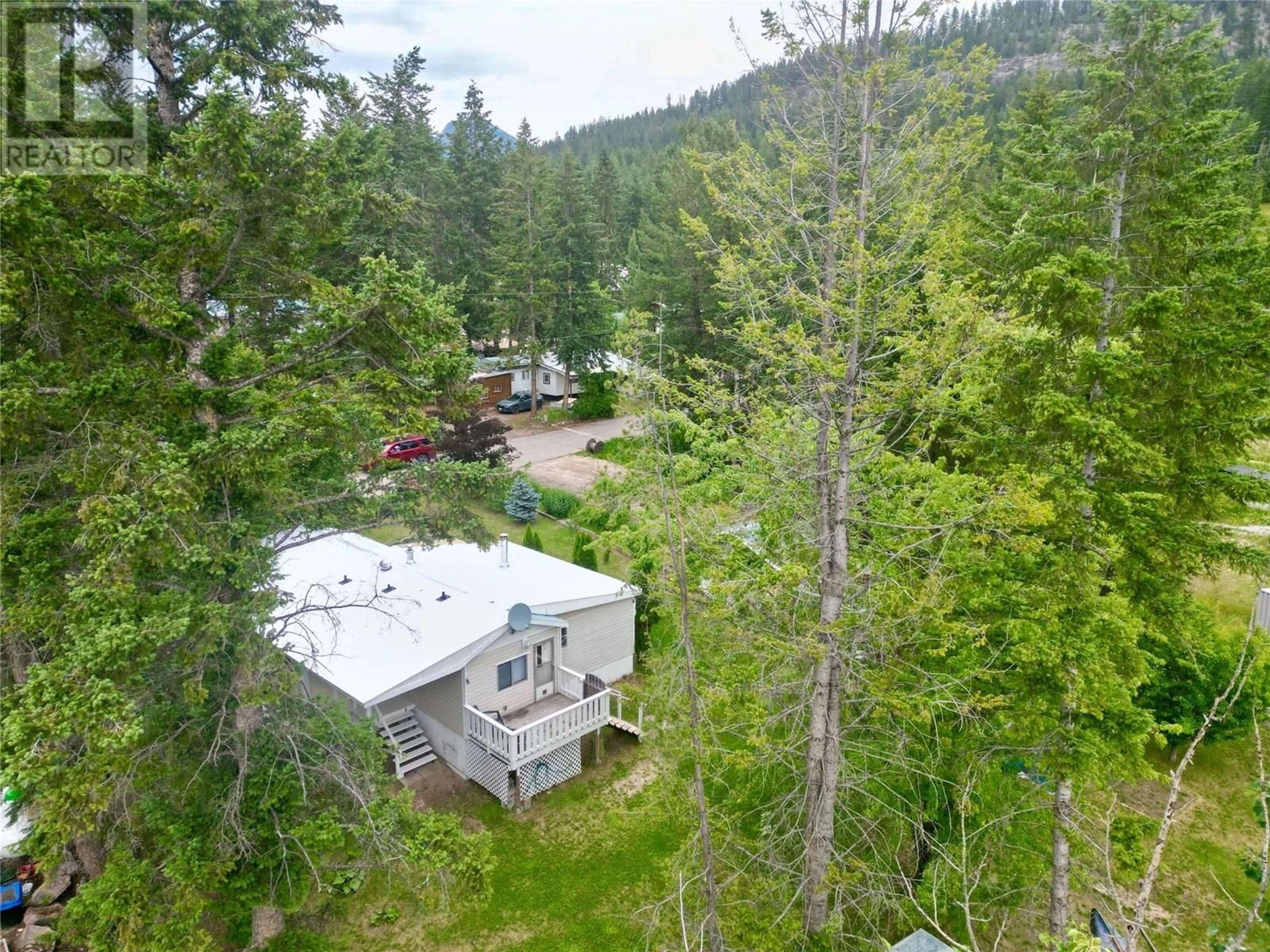 A pic from outside/outdoor area/front of a property/back of a property/a pic from drone, forest/trees view for 36 - 470 REFLECTION LAKE ROAD, Golden British Columbia V0A1H6