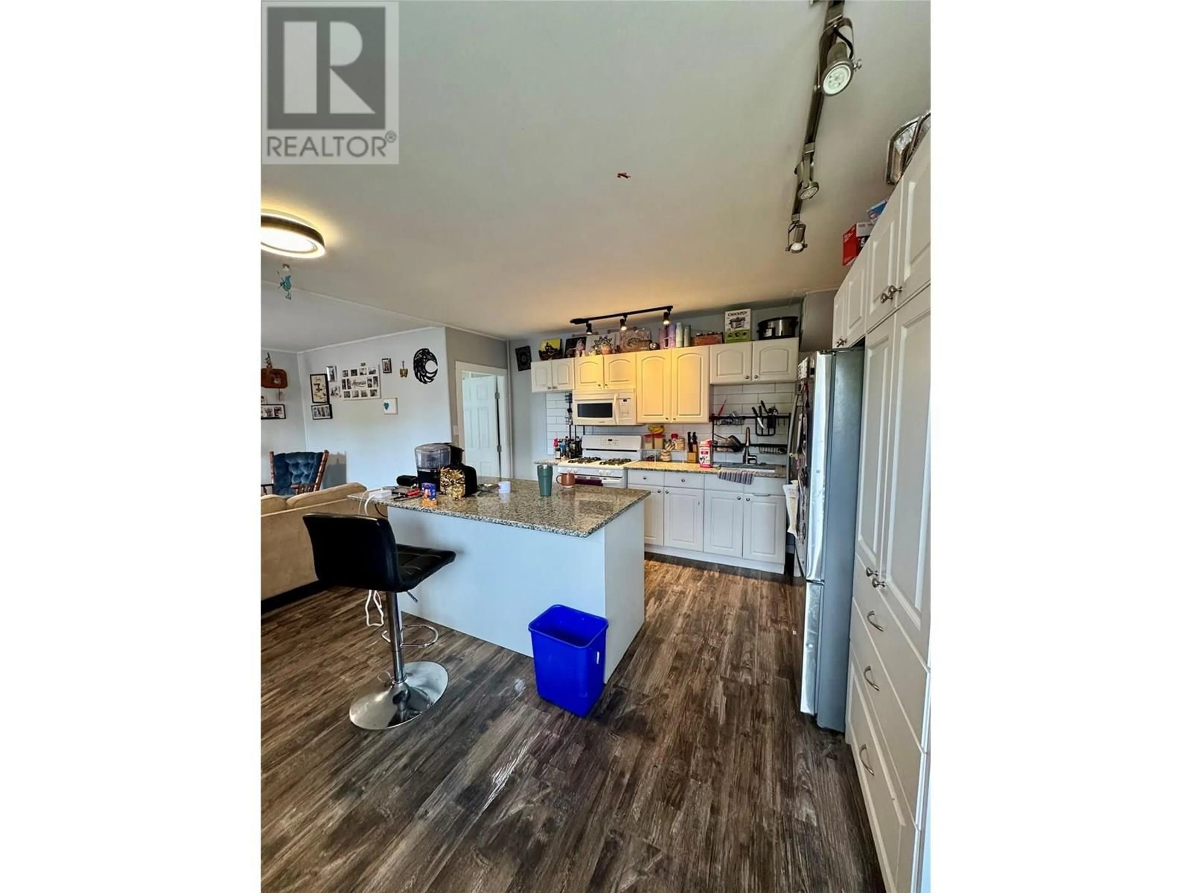 Open concept kitchen, wood/laminate floor for 2276 COUTLEE AVENUE, Merritt British Columbia V1K1R6