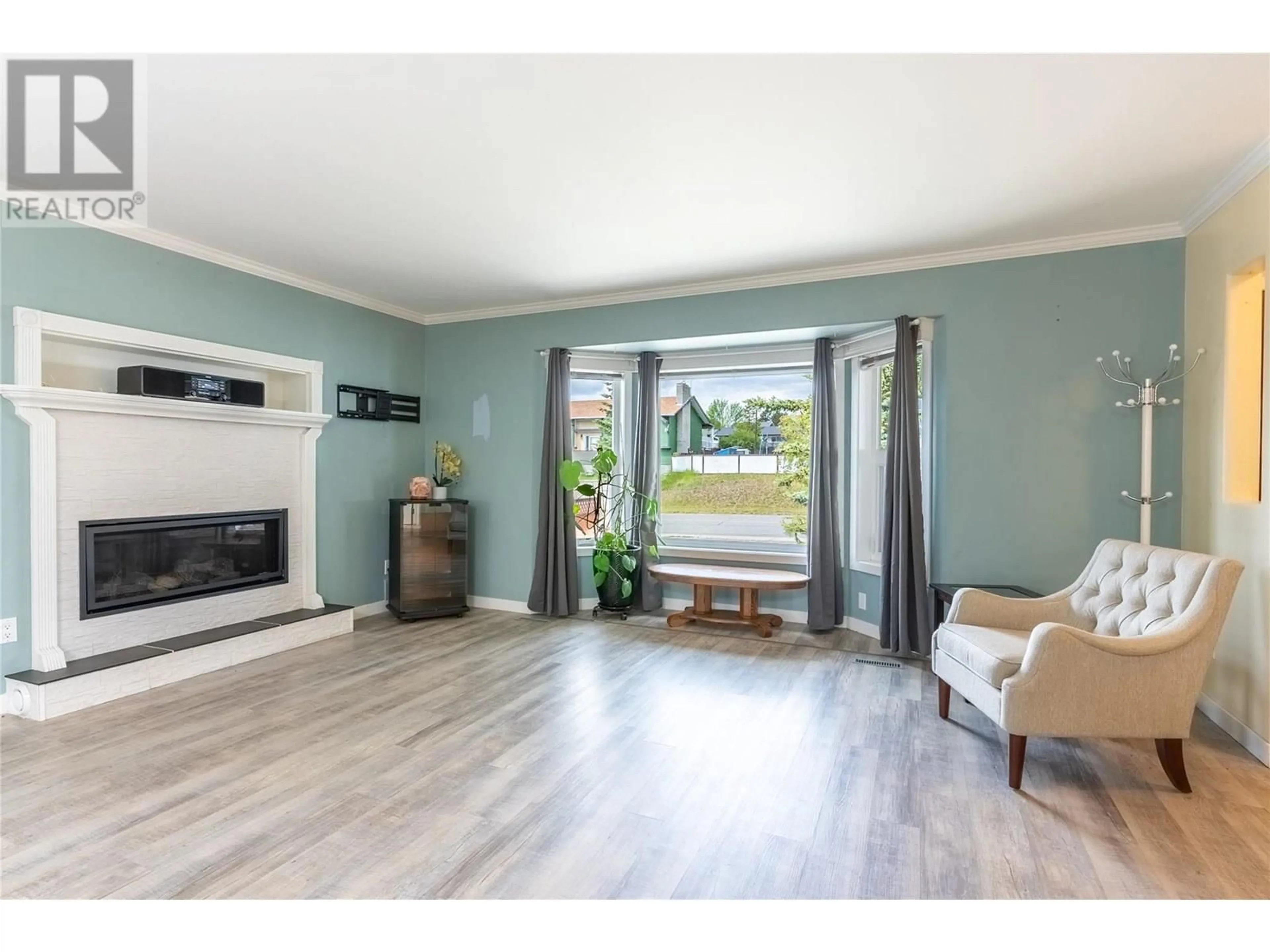Living room with furniture, wood/laminate floor for 207 PONDEROSA AVENUE, Logan Lake British Columbia V0K1W0