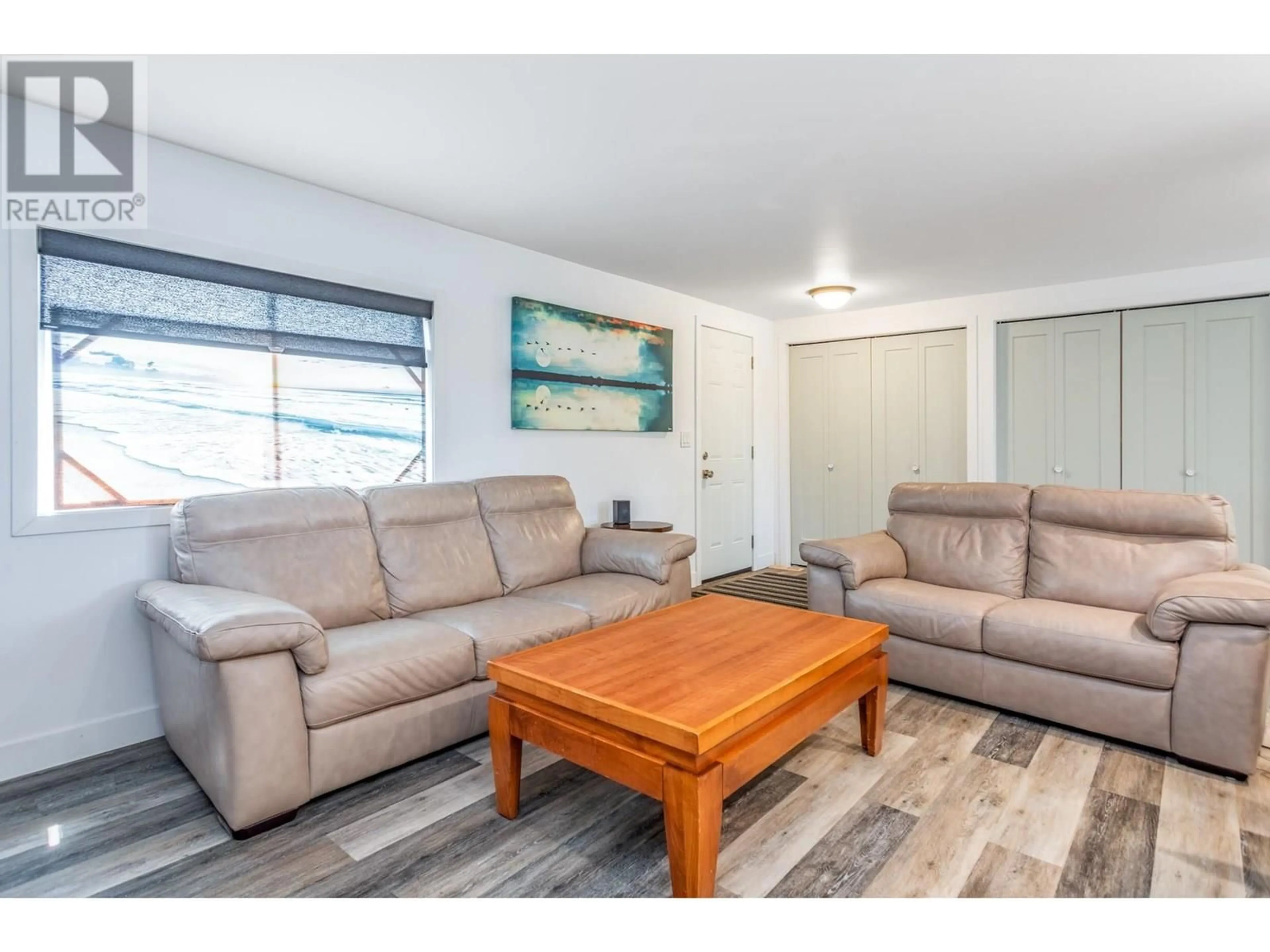 Living room with furniture, wood/laminate floor for 93 - 4075 MCCLAIN ROAD, Kelowna British Columbia V1W4R4