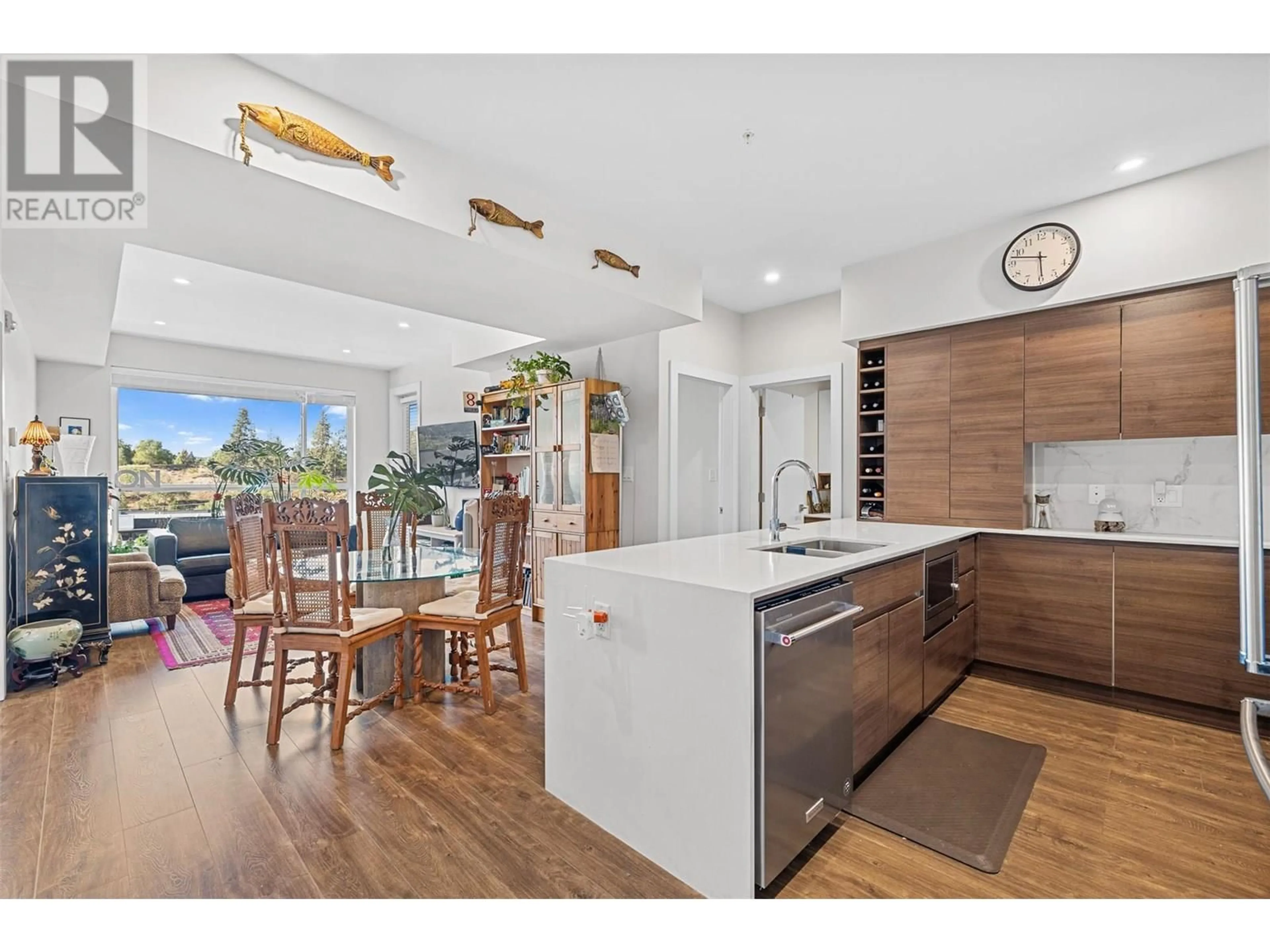 Open concept kitchen, wood/laminate floor for 606 - 1925 ENTERPRISE WAY, Kelowna British Columbia V1Y9S9