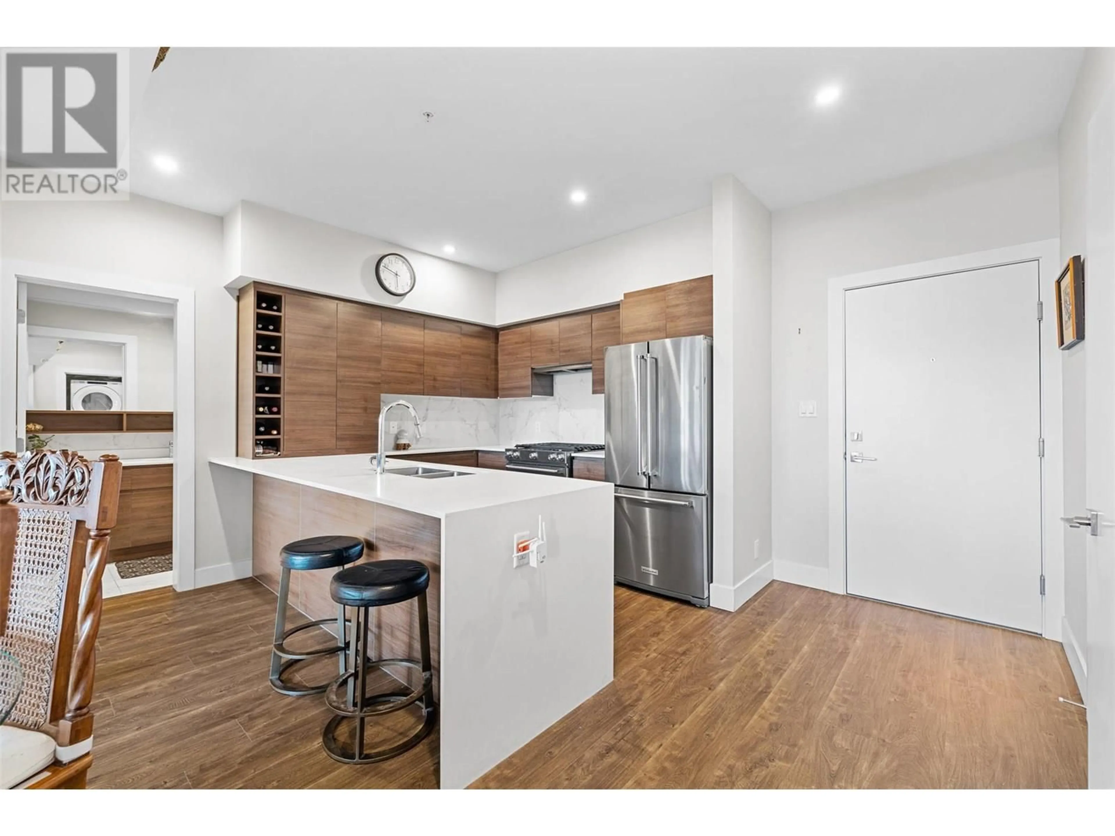 Open concept kitchen, wood/laminate floor for 606 - 1925 ENTERPRISE WAY, Kelowna British Columbia V1Y9S9