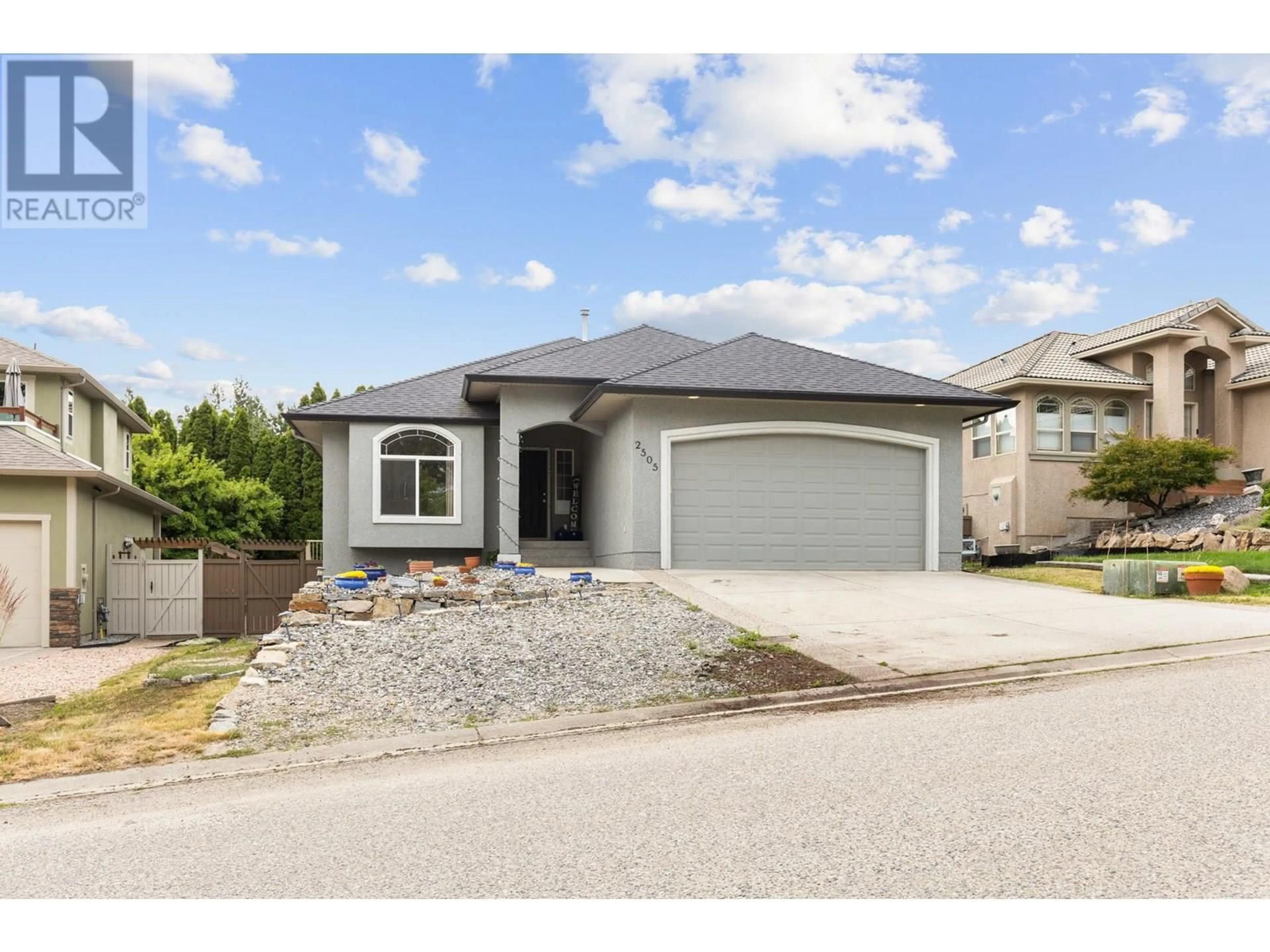 Home with vinyl exterior material, street for 2505 QUAIL PLACE, Kelowna British Columbia V1V1Z8