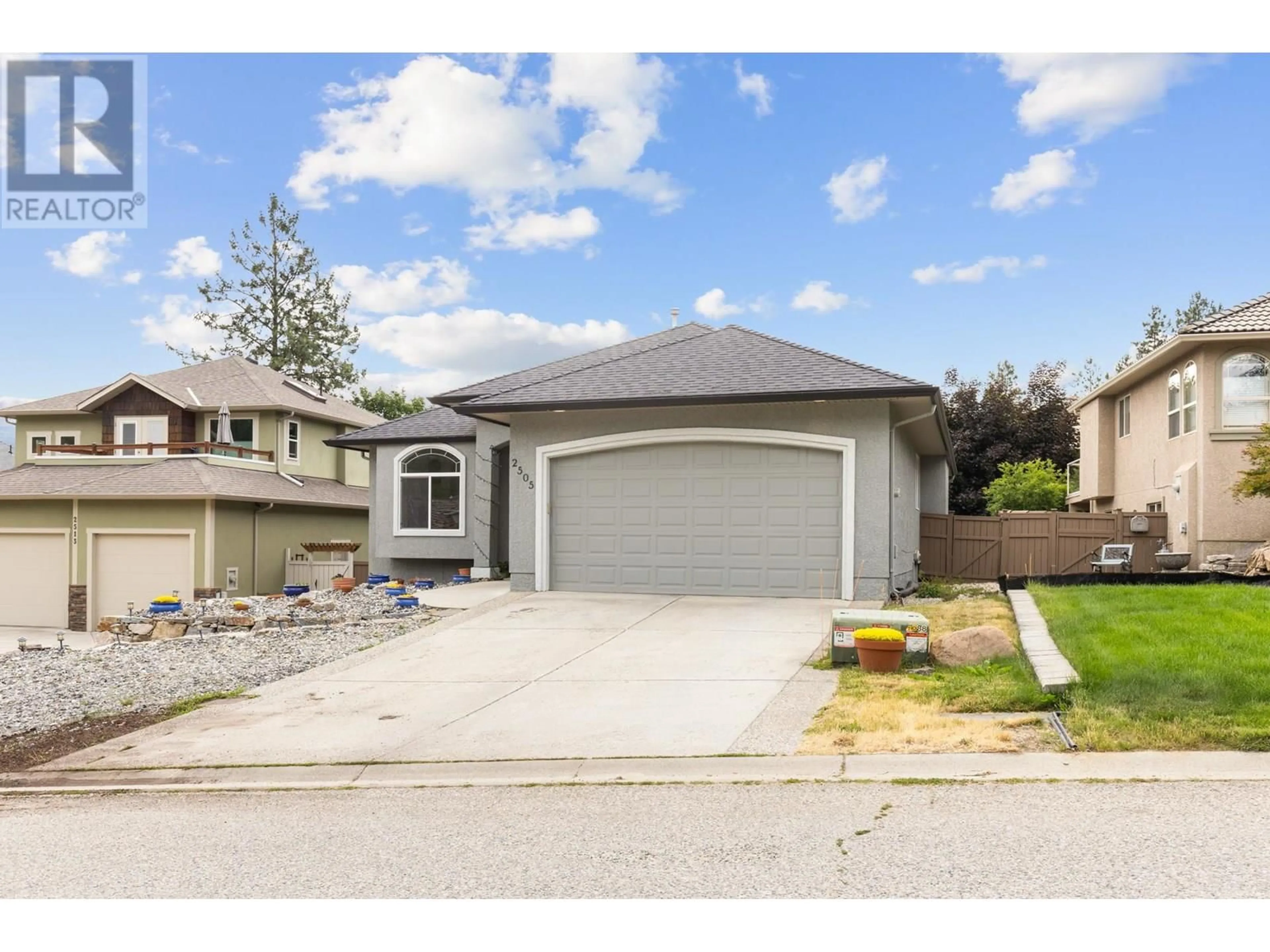 Home with vinyl exterior material, street for 2505 QUAIL PLACE, Kelowna British Columbia V1V1Z8