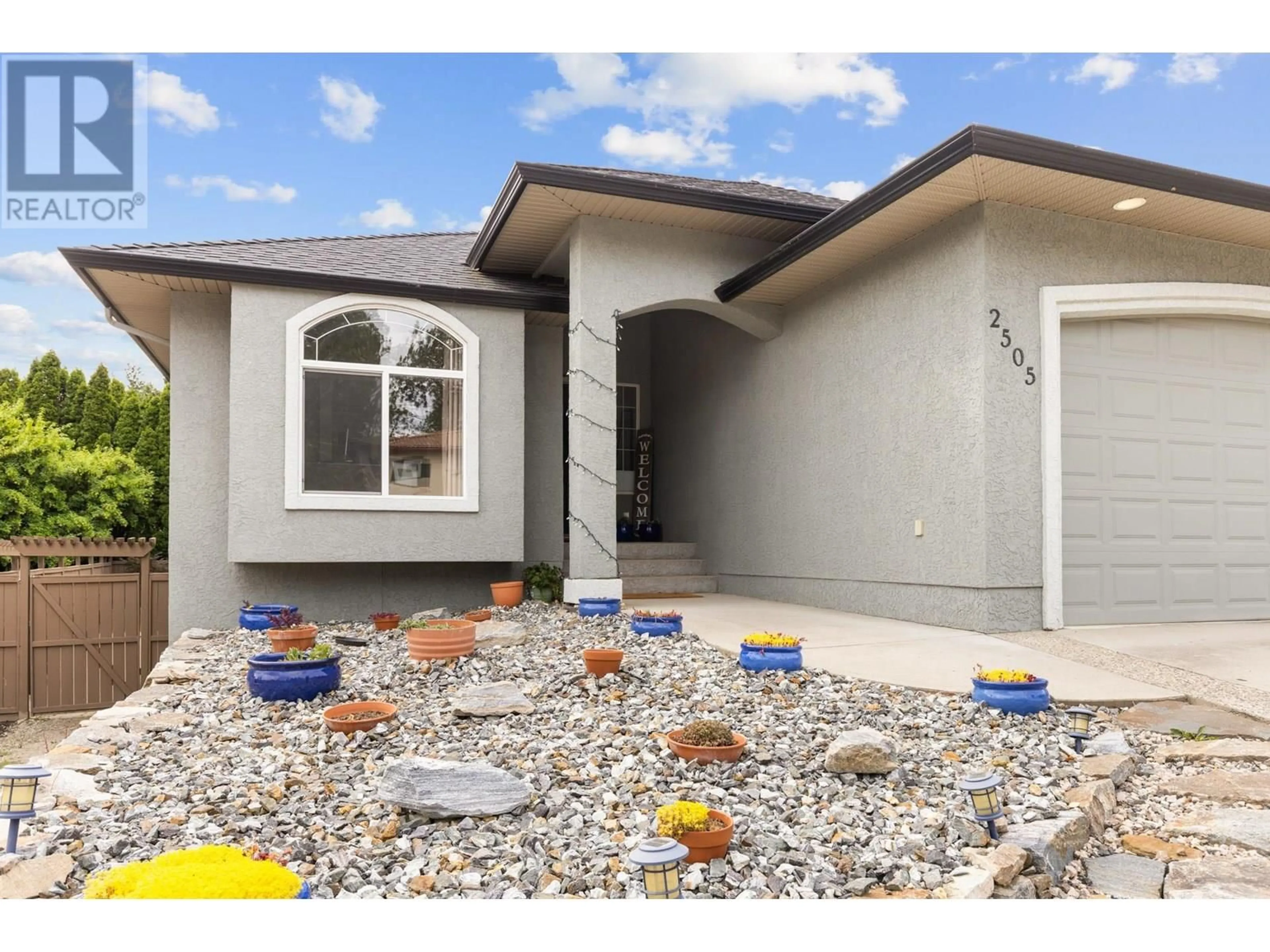 Home with vinyl exterior material, street for 2505 QUAIL PLACE, Kelowna British Columbia V1V1Z8