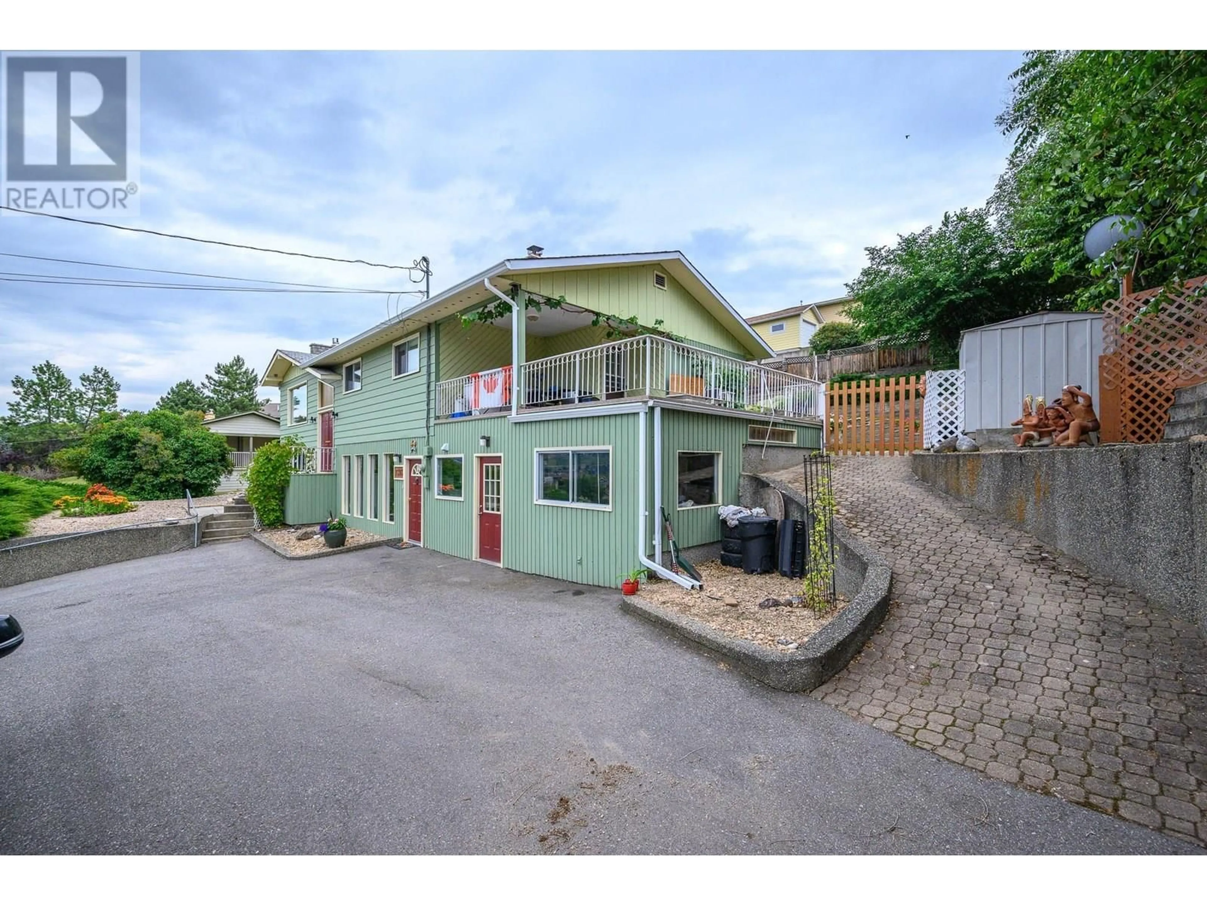 A pic from outside/outdoor area/front of a property/back of a property/a pic from drone, street for 7393 LONGACRE DRIVE, Vernon British Columbia V1H1R5